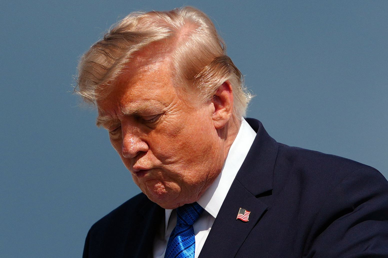 US President Donald Trump gestures while stepping off Air Force One upon arrival at Morristown Municipal Airport in Morristown, New Jersey, on July 31, 2026.
