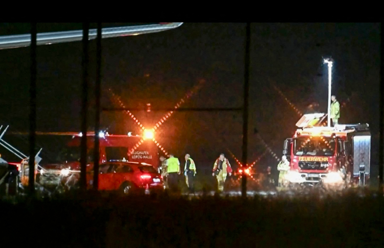 A video grab taken from a video footage by News5 from August 5, 2026 shows emergency services, police and firefighers deployed at German airport Leipzig-Halle in Schkeuditz, eastern Germany