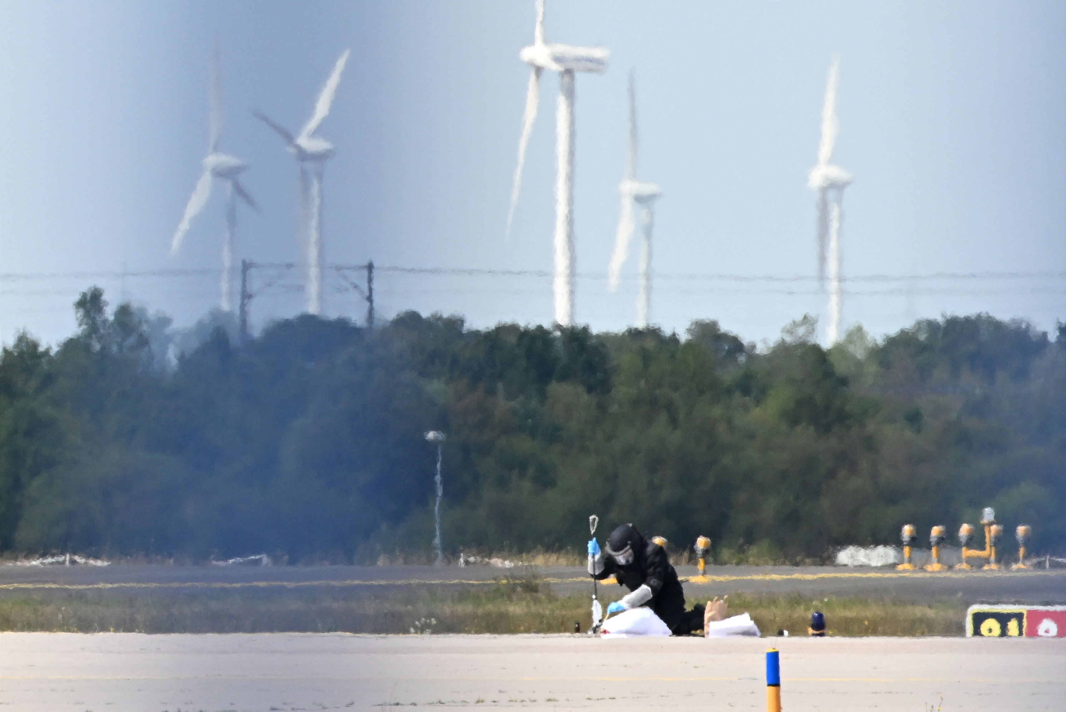 A forensic technician works at the German airport Leipzig-Halle in Schkeuditz, eastern Germany, after an explosives-laden drone was found near a Ukrainian cargo plane.