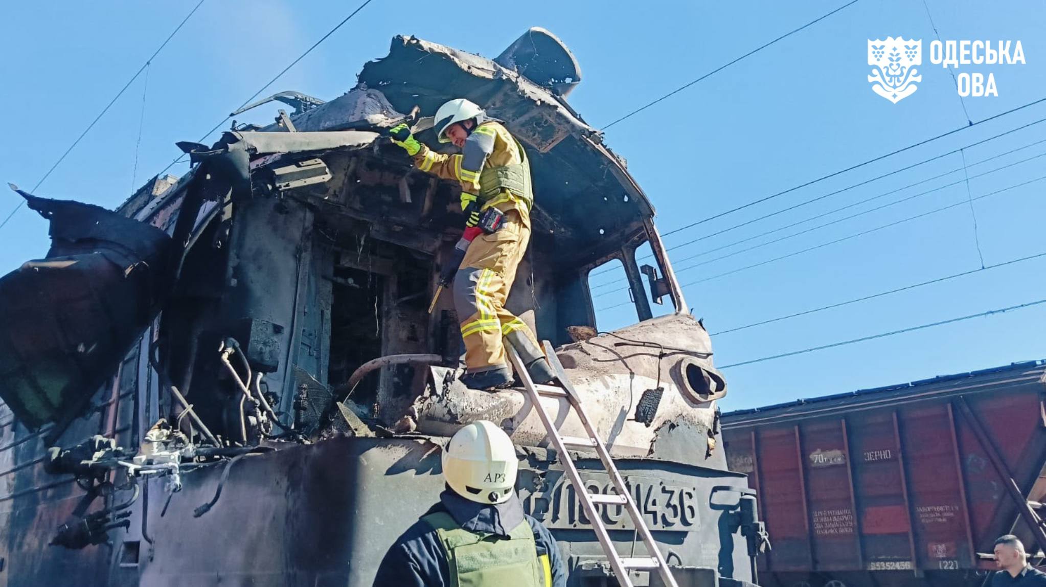 Rescuers work at the site of a damaged train.