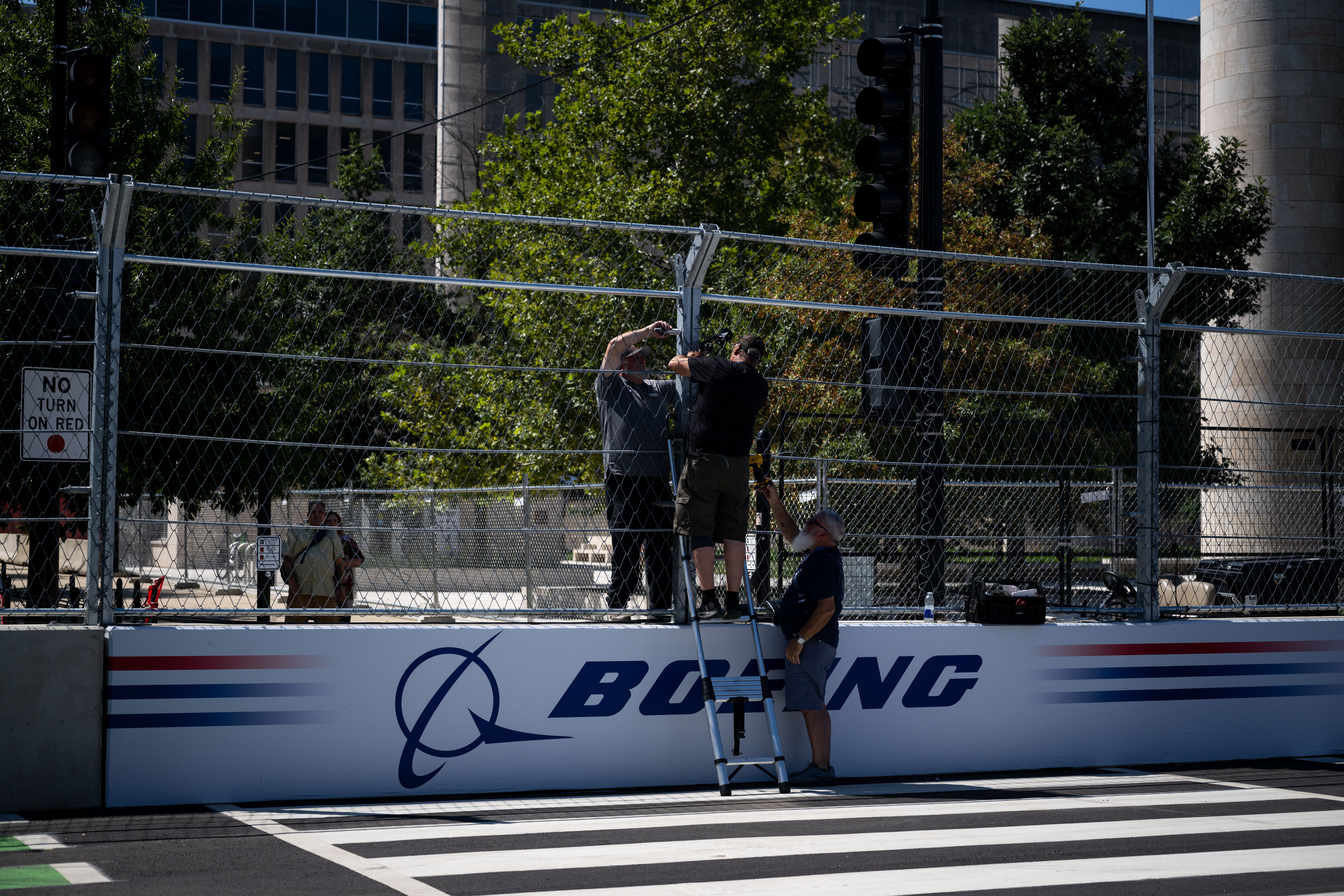 Workers continue setting up ahead of the Freedom 250 Grand Prix on the National Mall in Washington, DC, on August 19, 2026.