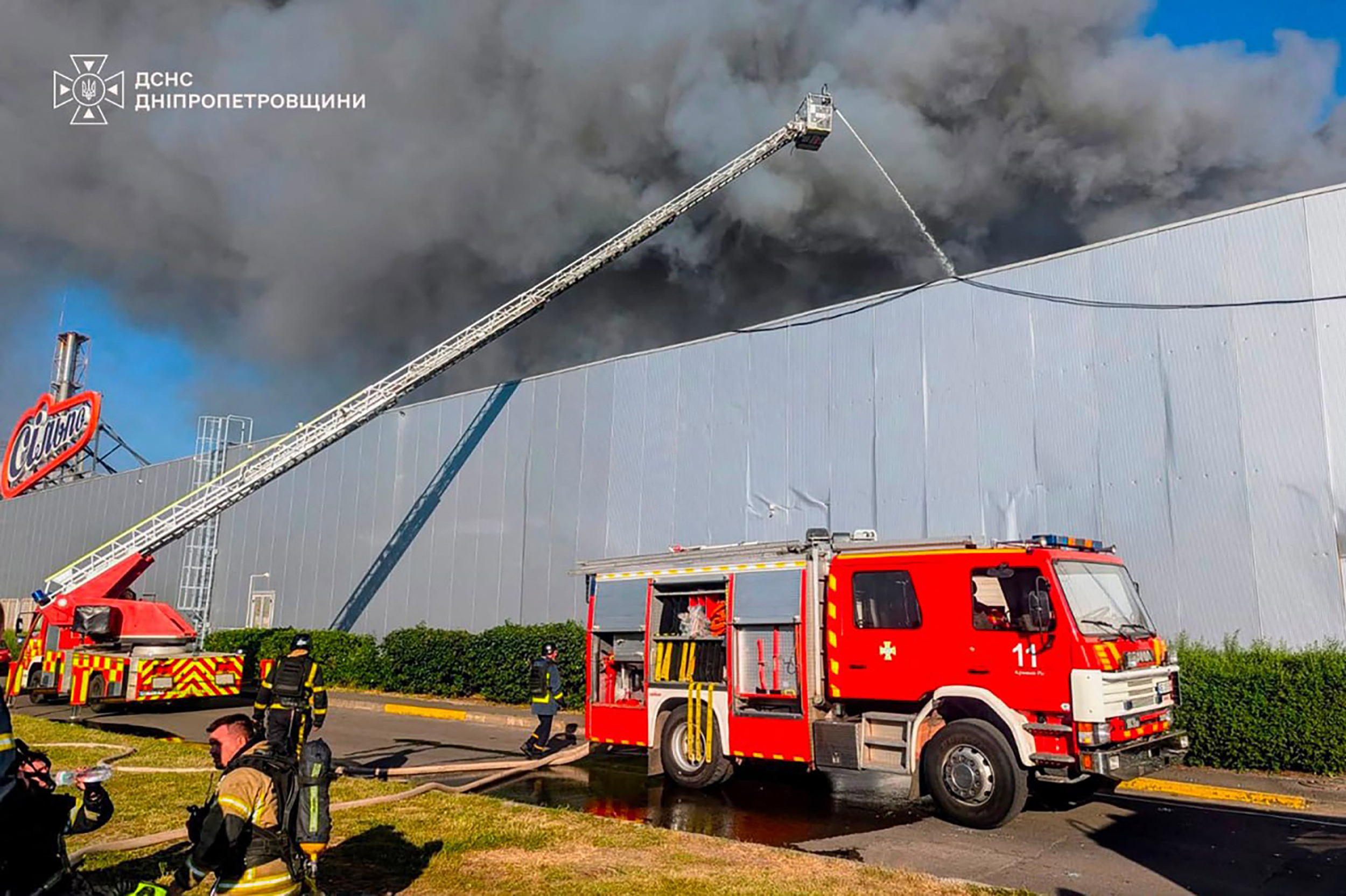 This handout photograph taken and released by the Ukrainian State Emergency Service on August 21, 2026 shows firefighters taking part in operations against a fire at the site of a shopping mall damaged following a Russian strike in Kryvyi Rih amid the Russian invasion of Ukraine.