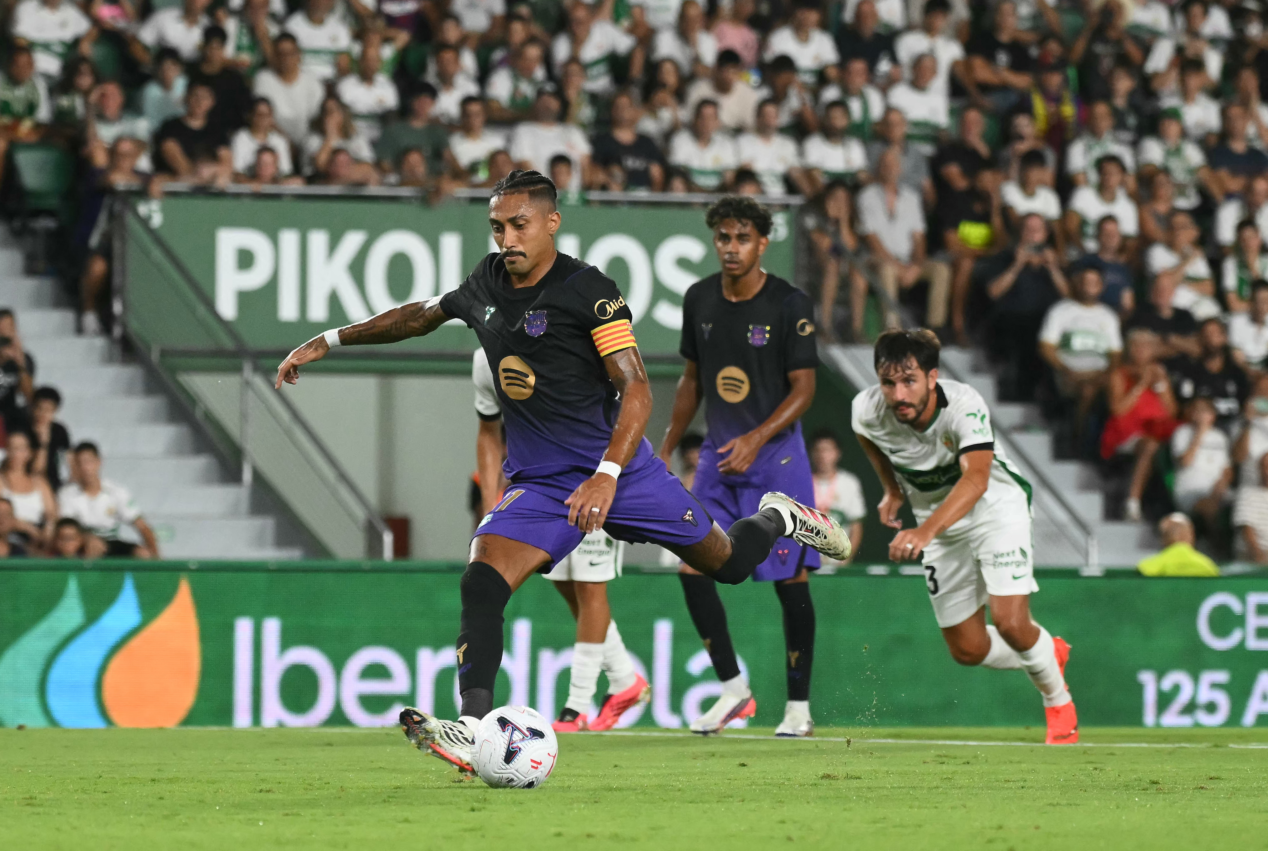 Barcelona's Brazilian forward #11 Raphinha kicks to score his team's first goal during the Spanish league football match between Elche CF and FC Barcelona at Martinez Valero Stadium in Elche on August 23, 2026. (Photo by JOSE JORDAN / AFP)