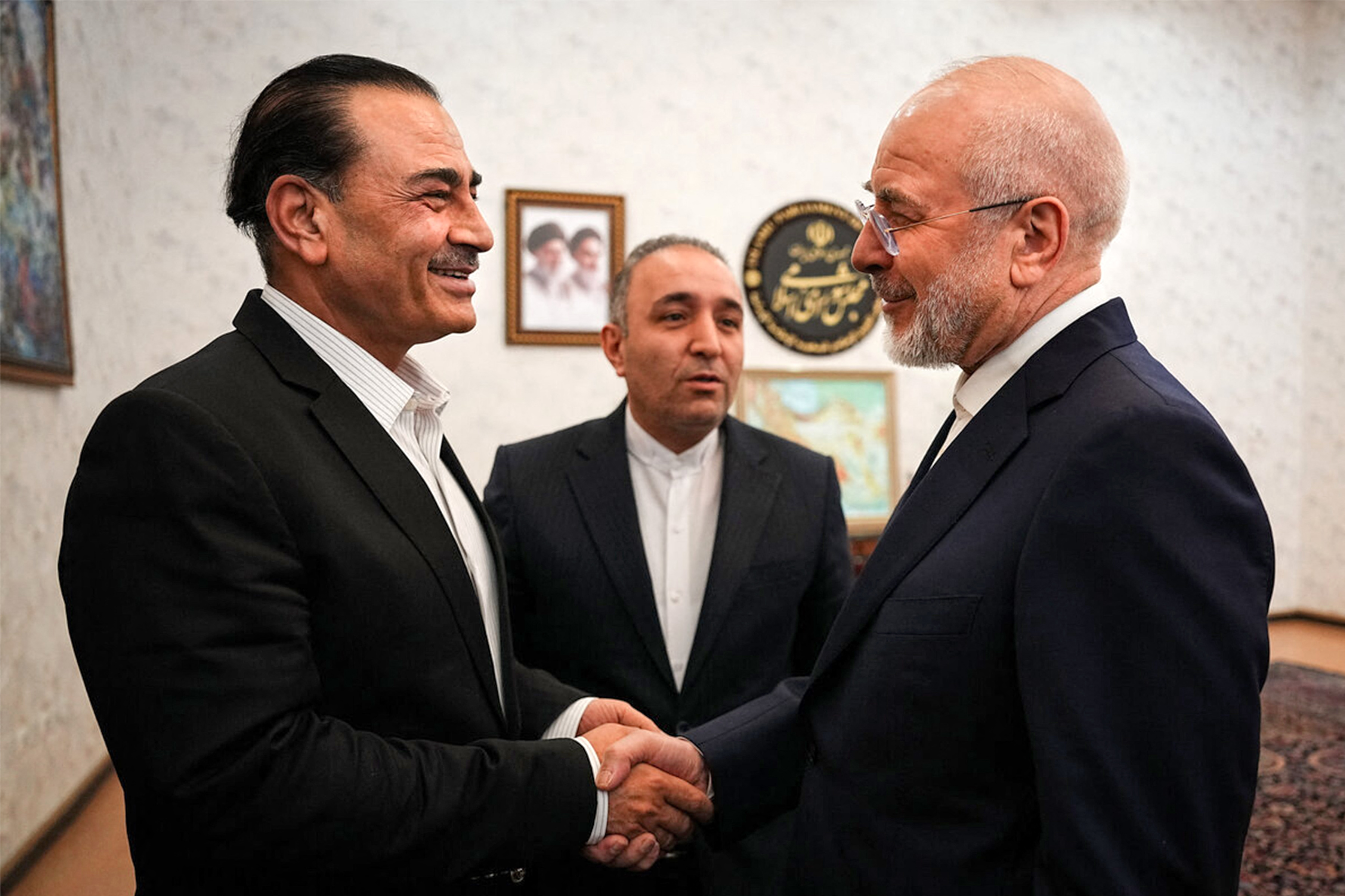 This handout picture provided by Iran’s parliament speaker’s office shows Speaker Mohammad Bagher Ghalibaf, right, receiving Pakistan’s army chief Field Marshall Asim Munir in Tehran on August 24, 2026 [AFP]