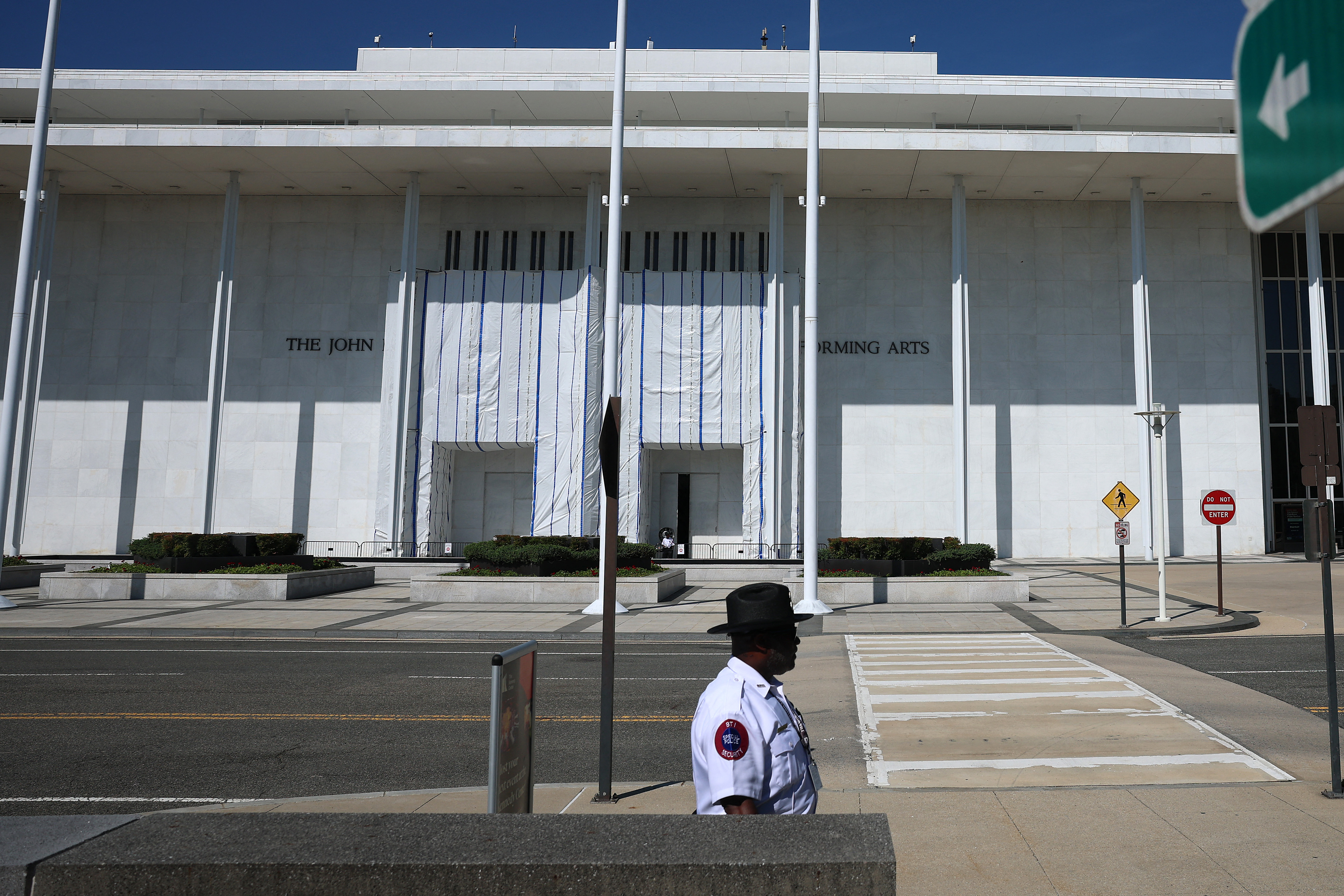 WASHINGTON, DC - AUGUST 25: A tarp remains in place on the facade of the John F. Kennedy Center for the Performing Arts on August 25, 2026 in Washington, DC. Lawyers for the center said a tarp originally set up outside during the removal of President Trump’s name will remain while crews conduct structural repairs. Since attempting to add President Trump's name to the center, ticket sales and fundraising efforts have collapsed, according to a Washington Post report. Kevin Dietsch/Getty Images/AFP (Photo by Kevin Dietsch / GETTY IMAGES NORTH AMERICA / Getty Images via AFP)