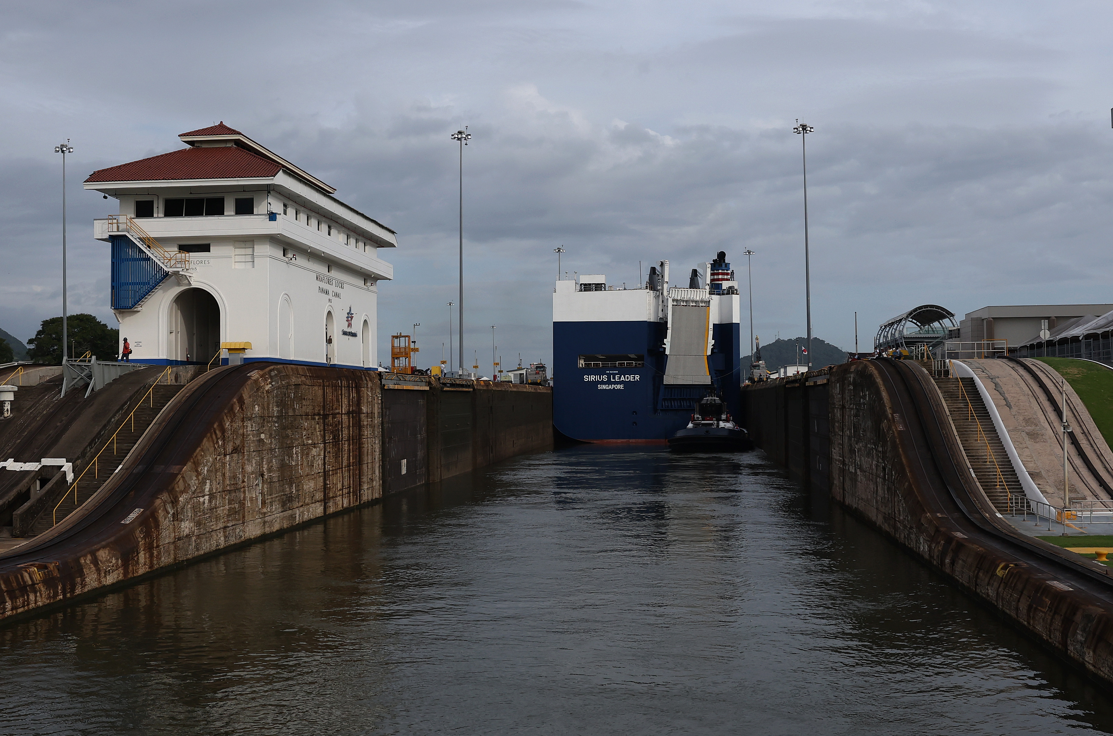 PANAMA CITY, PANAMA - SEPTEMBER 23: Vehicle carrier Sirius Leader passes through the Miraflores locks while transiting the Panama Canal on September 23, 2023 in Panama City, Panama. The Panama Canal Authority is continuing to restrict the number of vessels that pass through the Panama Canal locks as drought has caused water levels at Gatun Lake to drop. The locks depend on millions of gallons of fresh water from the manmade lake to fill locks in Panama City and Colon in order to transit shipping vessels from the Pacific Ocean to the Caribbean Sea. Over 100 ships are waiting to transit the canal and the backup could delay goods heading to the United States for the holiday season. It takes an average of 8-10 hours for a ship to transit the 50 miles through the canal versus several weeks to travel thousands of miles around Cape Horn and the southernmost parts of South America. (Photo by Justin Sullivan/Getty Images)