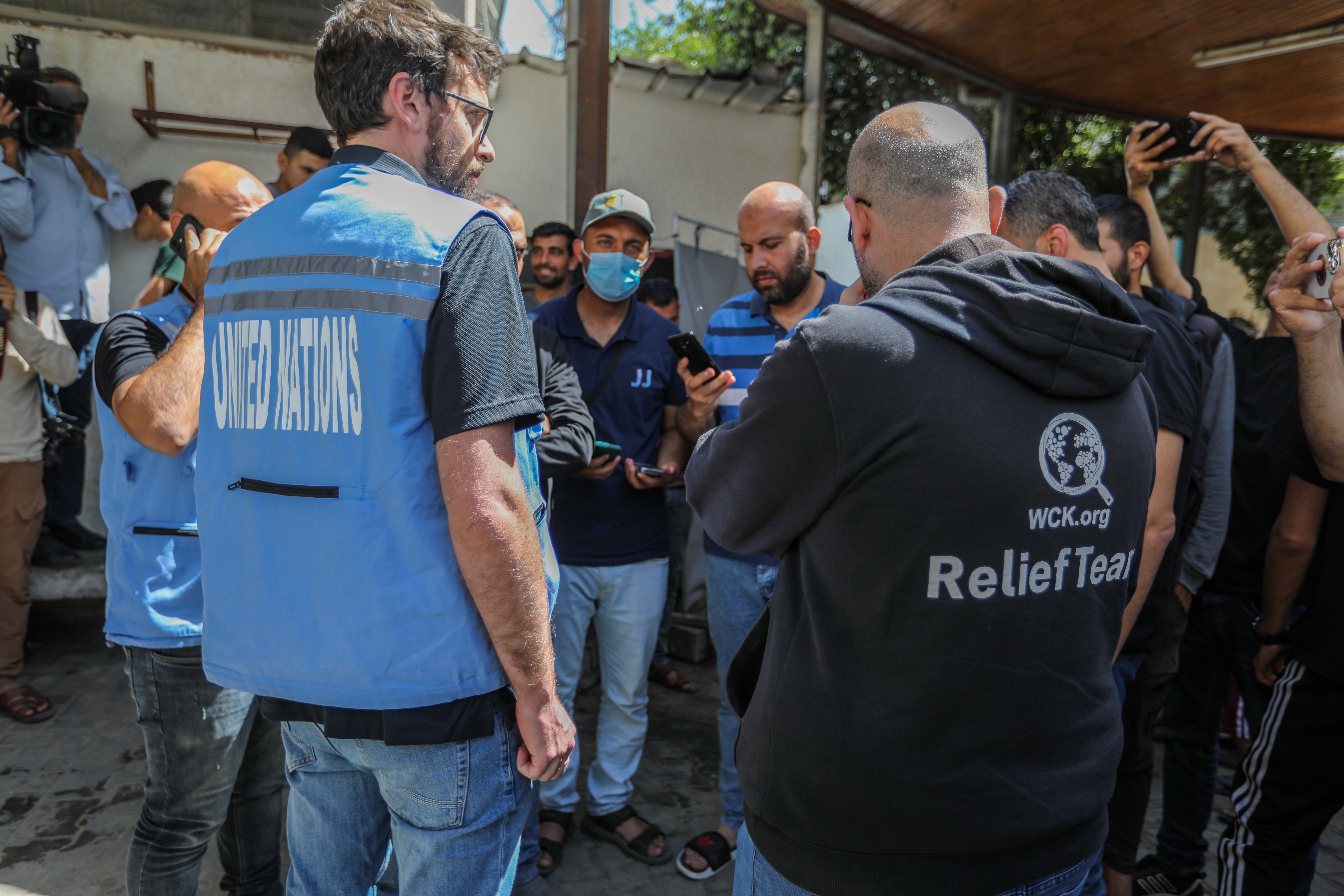 Medics inspect the site where World Central Kitchen workers were killed by an Israeli air strike while driving in a convoy after leaving a warehouse in Deir al-Balah, Gaza. [Ahmad Hasaballah/Getty Images]