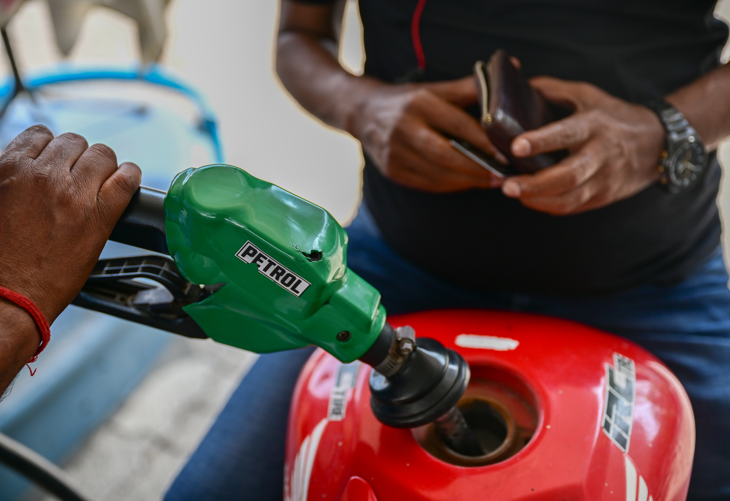 NEW DELHI, INDIA - MARCH 10: A fuel pump attendant refuels a bike at a fuel station on March 10, 2026 in New Delhi, India. Oil prices whipsawed from historic highs back to around $90 a barrel, after U.S. President Trump's latest remarks on the Iran conflict. Markets remain in flux as the situation continues to evolve. (Photo by Ritesh Shukla/Getty Images)