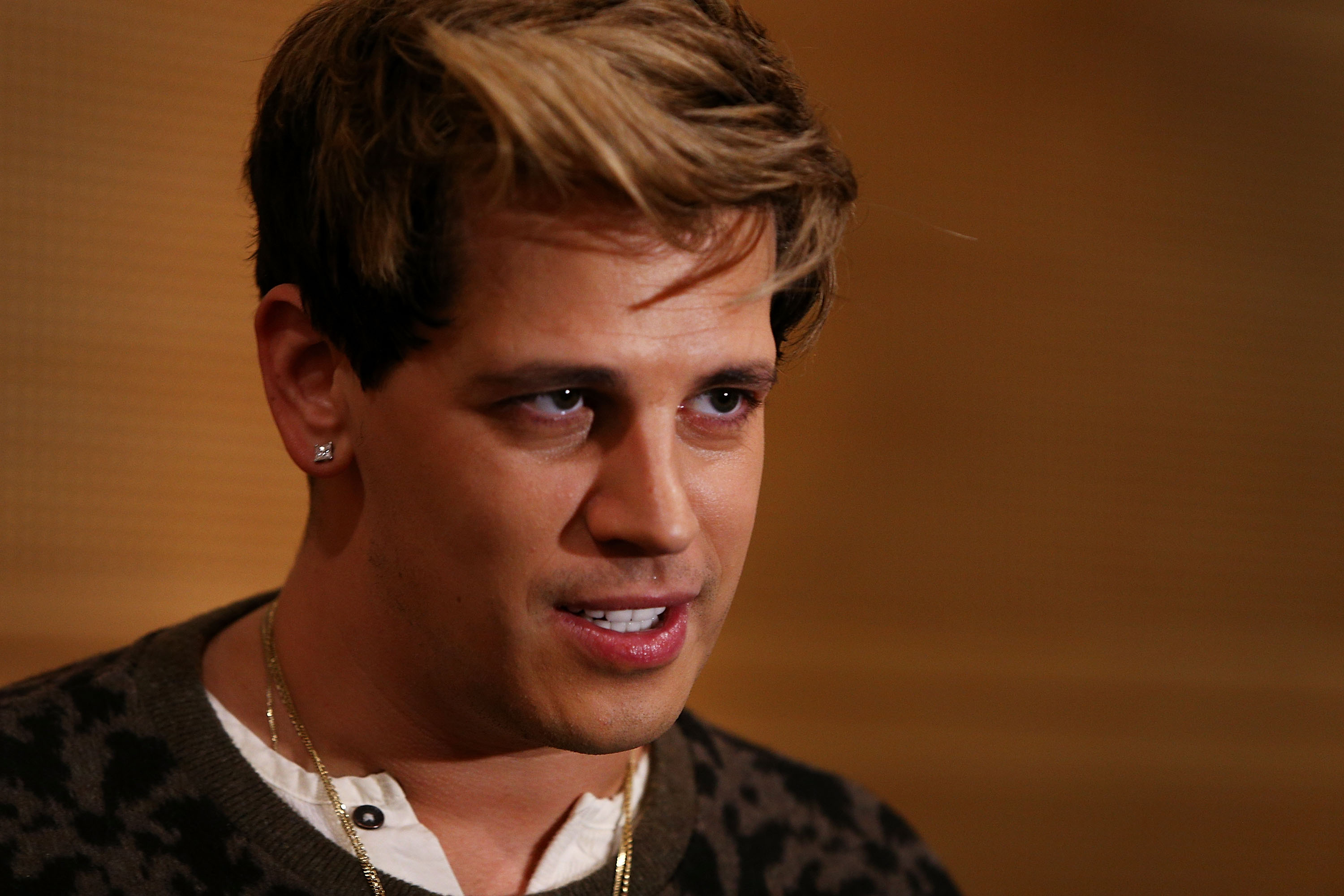 SYDNEY, AUSTRALIA - NOVEMBER 29: Milo Yiannopoulos reacts during a press conference on arrival at the Sydney International Airport on November 29, 2017 in Sydney, Australia. Yiannopoulos is in Australia for his Troll Academy Tour. (Photo by Lisa Maree Williams/Getty Images)