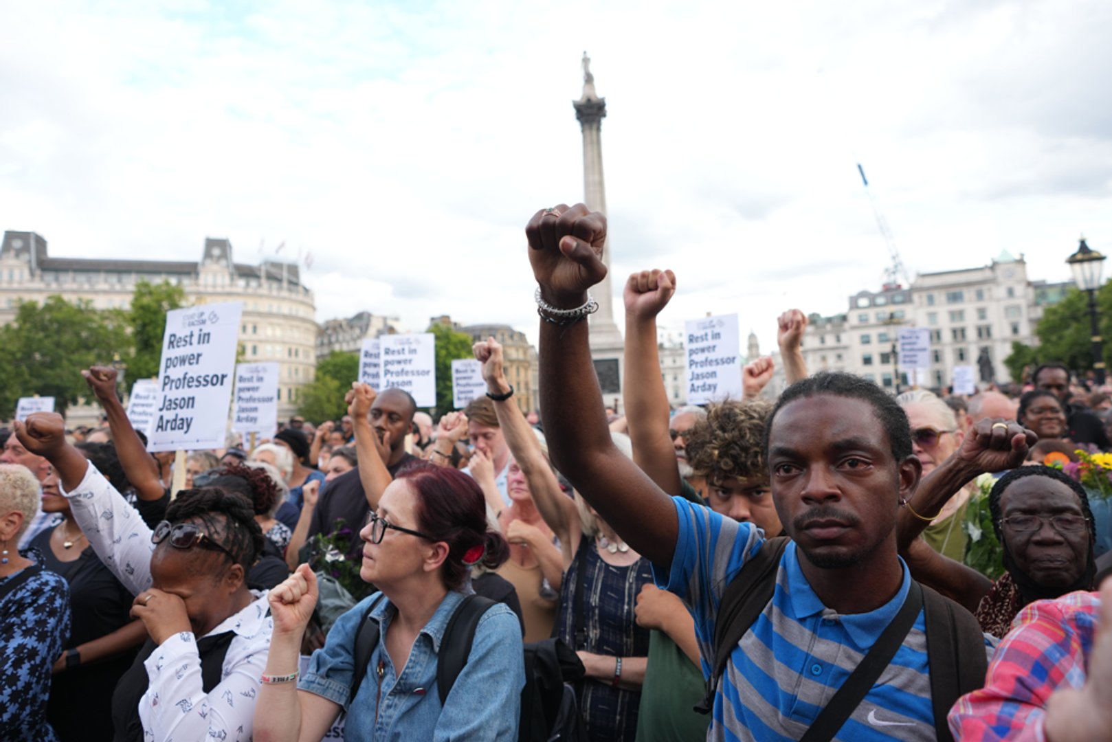 People gesture as they attend a vigil held by Stand Up to Racism, in memory of late University of Cambridge professor Jason Arday, in Trafalgar Square in London, Monday, Aug. 17, 2026. (AP Photo/Kirsty Wigglesworth)