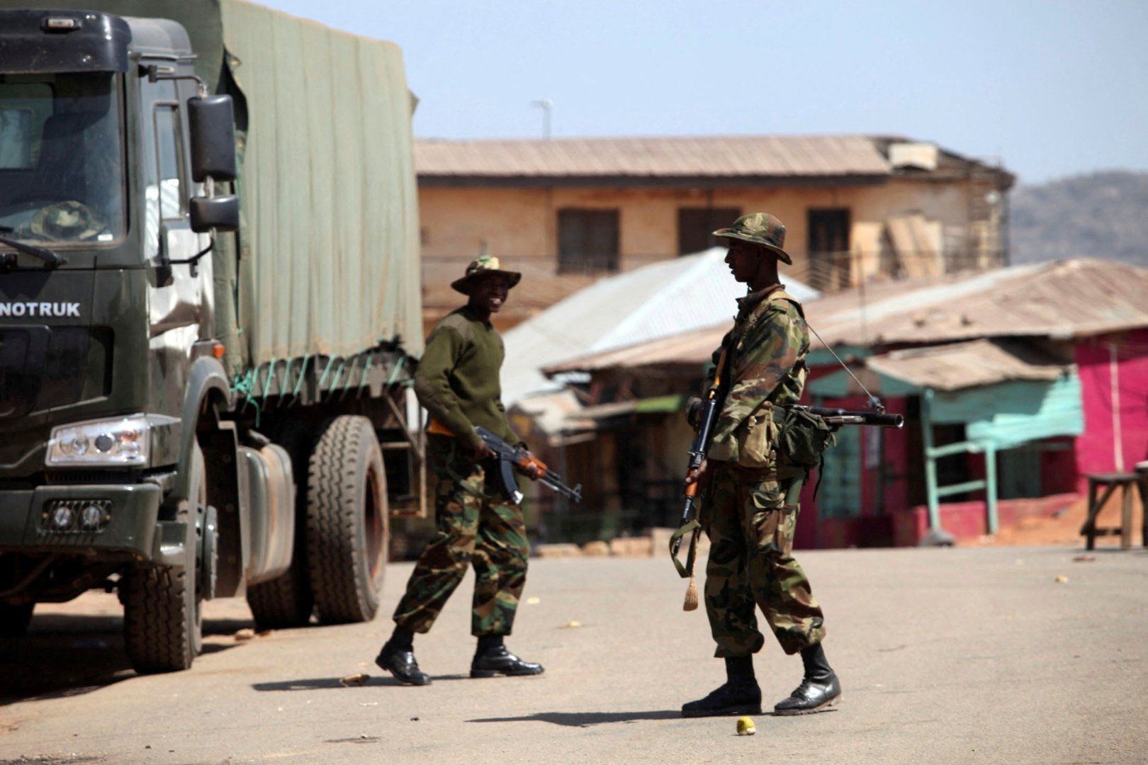 FILE PHOTO: Soldiers stand guard along a road in Nigeria's central city of Jos January 20, 2010. [Akintunde Akinleye/File Photo/Reuers]