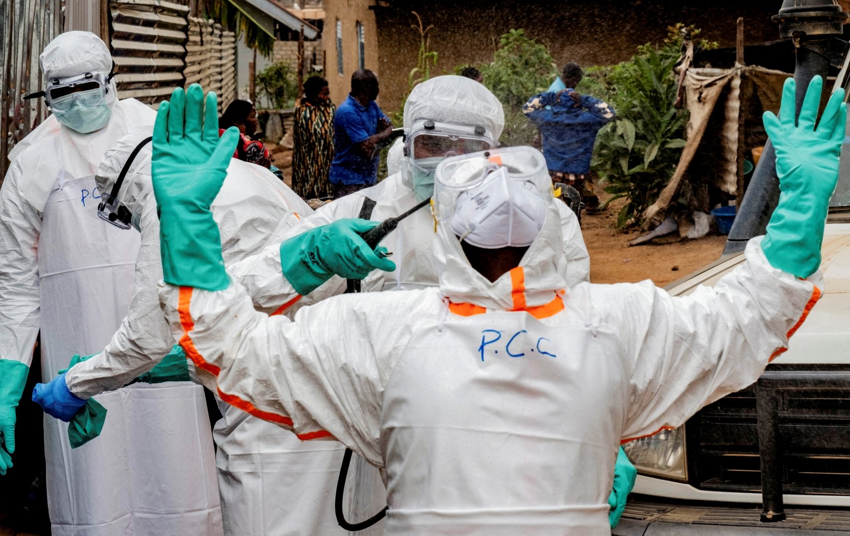 FILE PHOTO: Members of the Civil Protection team, which works to help mitigate the spread of the Ebola virus, wearing personal protective equipment (PPE), disinfect after handling the body of an unidentified man, who according to his family, died of Ebola, in Bunia, Ituri province, Democratic Republic of Congo, July 10, 2026. [Gradel Muyisa Mumbere/Reuters/File Photo]