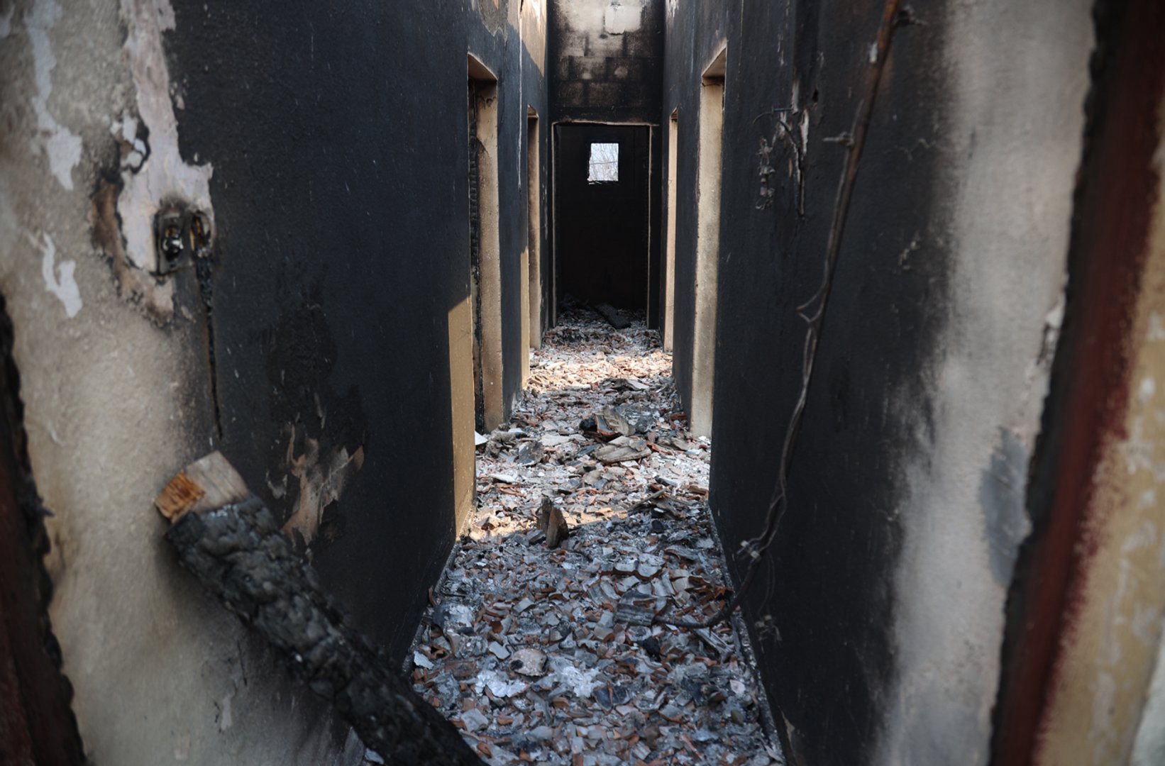 A view of the burned remains of a home in Jijel, Algeria, Thursday, Aug. 27, 2026. (AP Photo)
