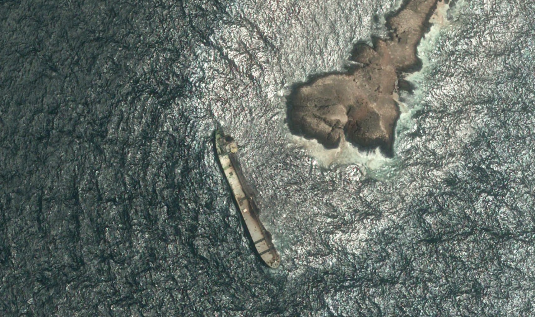 A satellite photo shows the tanker Caroline Bezengi, grounded and partly submerged off the coast of Oman, on August 5, 2026