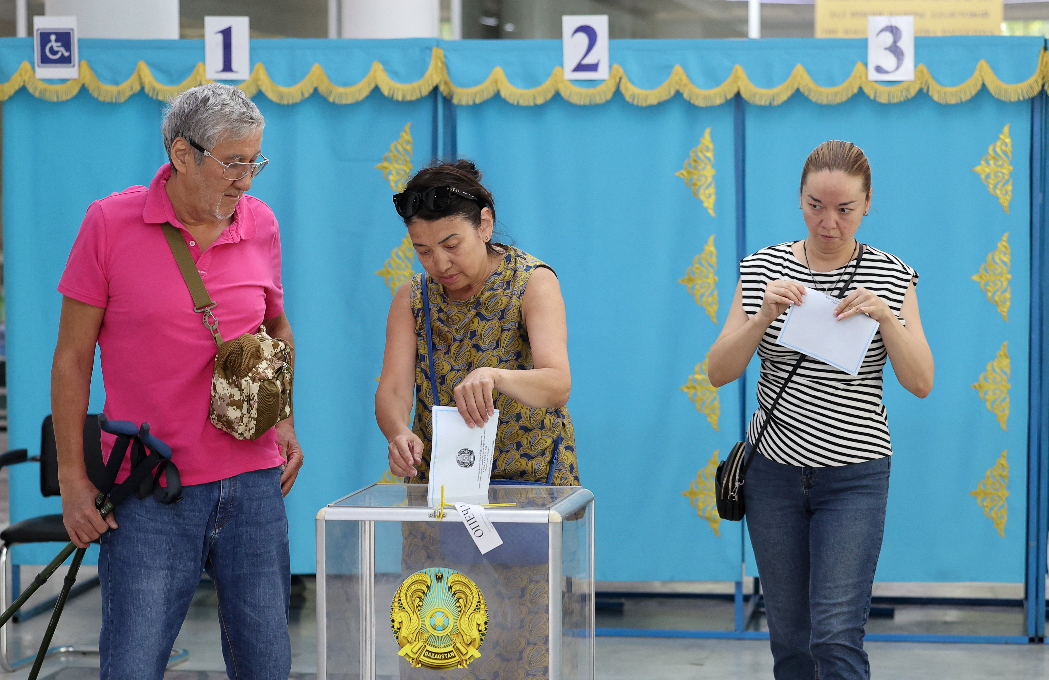 Voters visit a polling station during a snap parliamentary election in Almaty, Kazakhstan