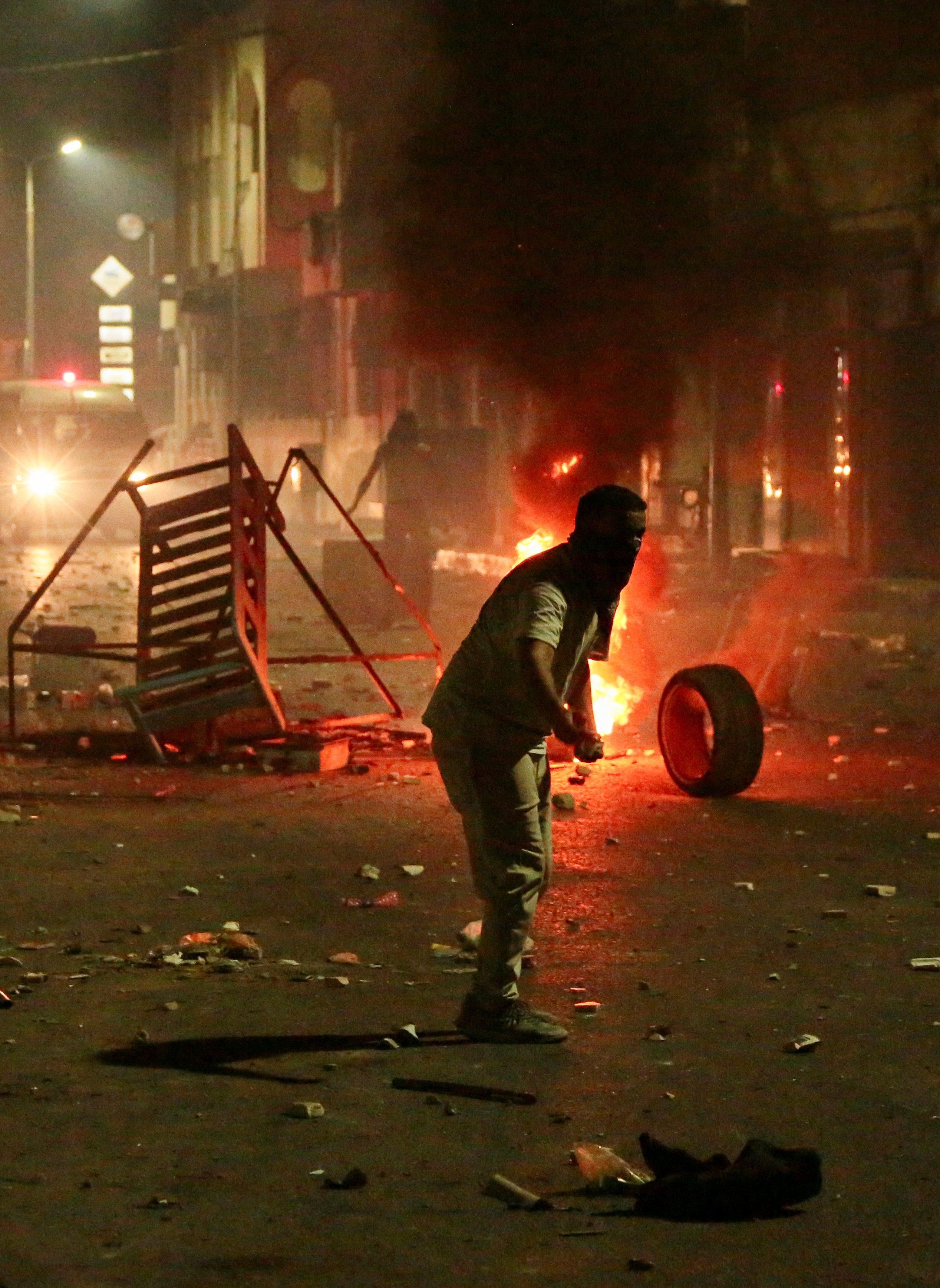 Fire burns on a street as demonstrators clash with security forces during a protest, following the sinking of a migrant boat bound for Italy, in Ben Guerdane, Tunisia, August 24, 2026. REUTERS/Ahmed Jarray
