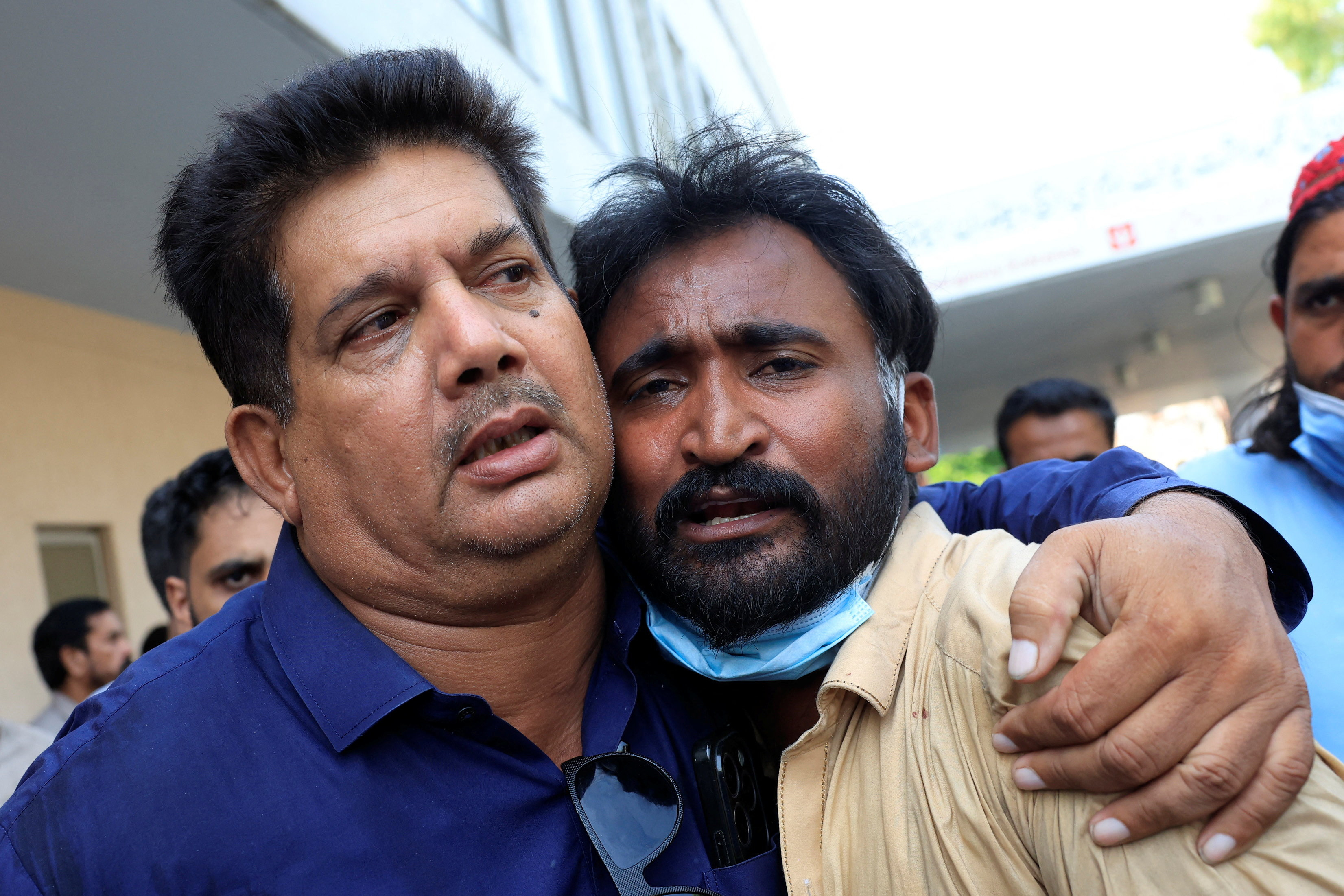 Samiullah, father of a newborn victim, is consoled following a deadly fire at the Pakistan Institute of Medical Sciences (PIMS) hospital in Islamabad, Pakistan, August 26, 2026. REUTERS/Akhtar Soomro