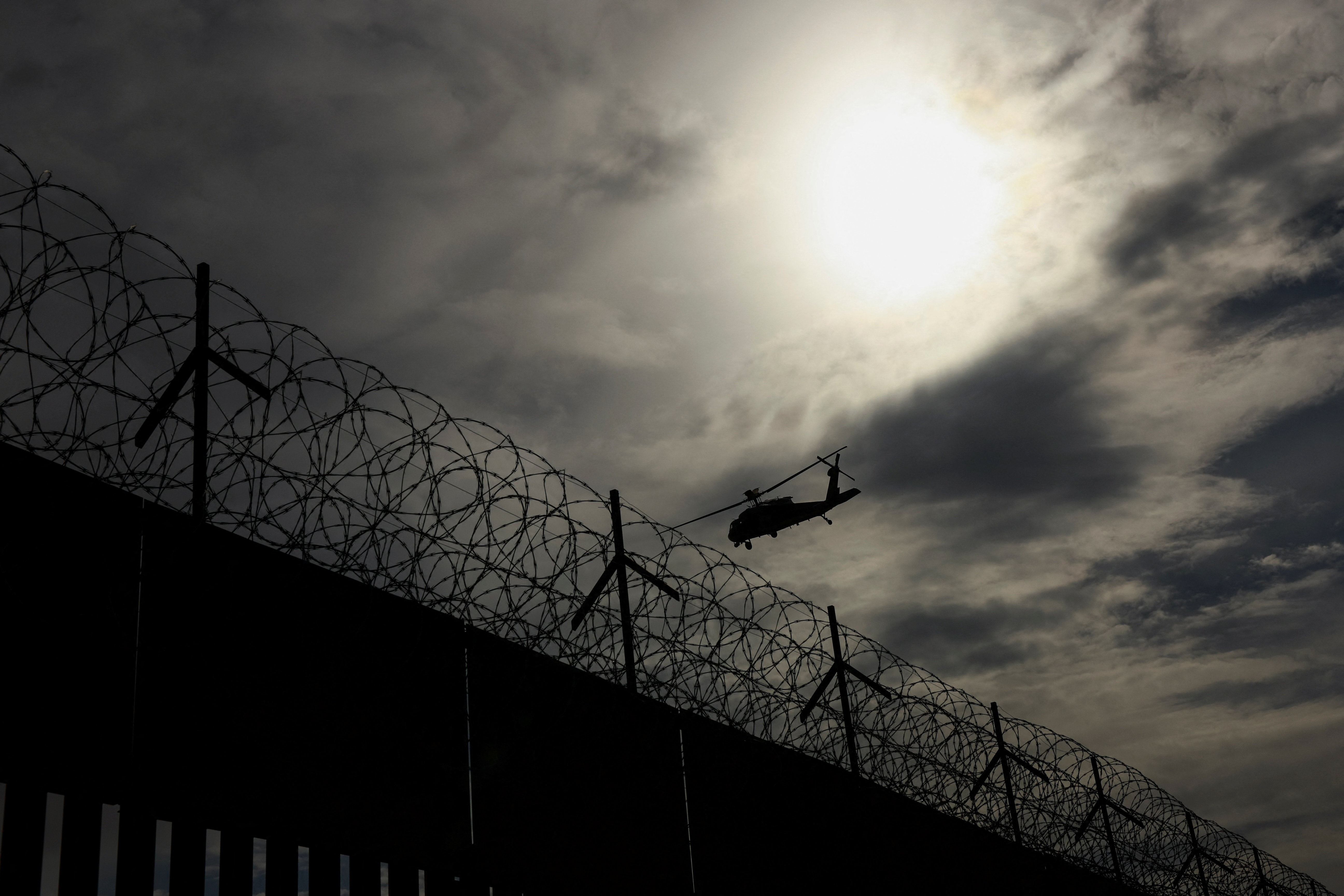 A U.S. Customs and Border Protection (CBP) Air and Marine Operations helicopter flies over a border wall during a border security operation after the U.S. designated the Mexican Juarez Cartel as a foreign terrorist organization (FTO), in El Paso, Texas, U.S., August 13, 2026. REUTERS/Jose Luis Gonzalez