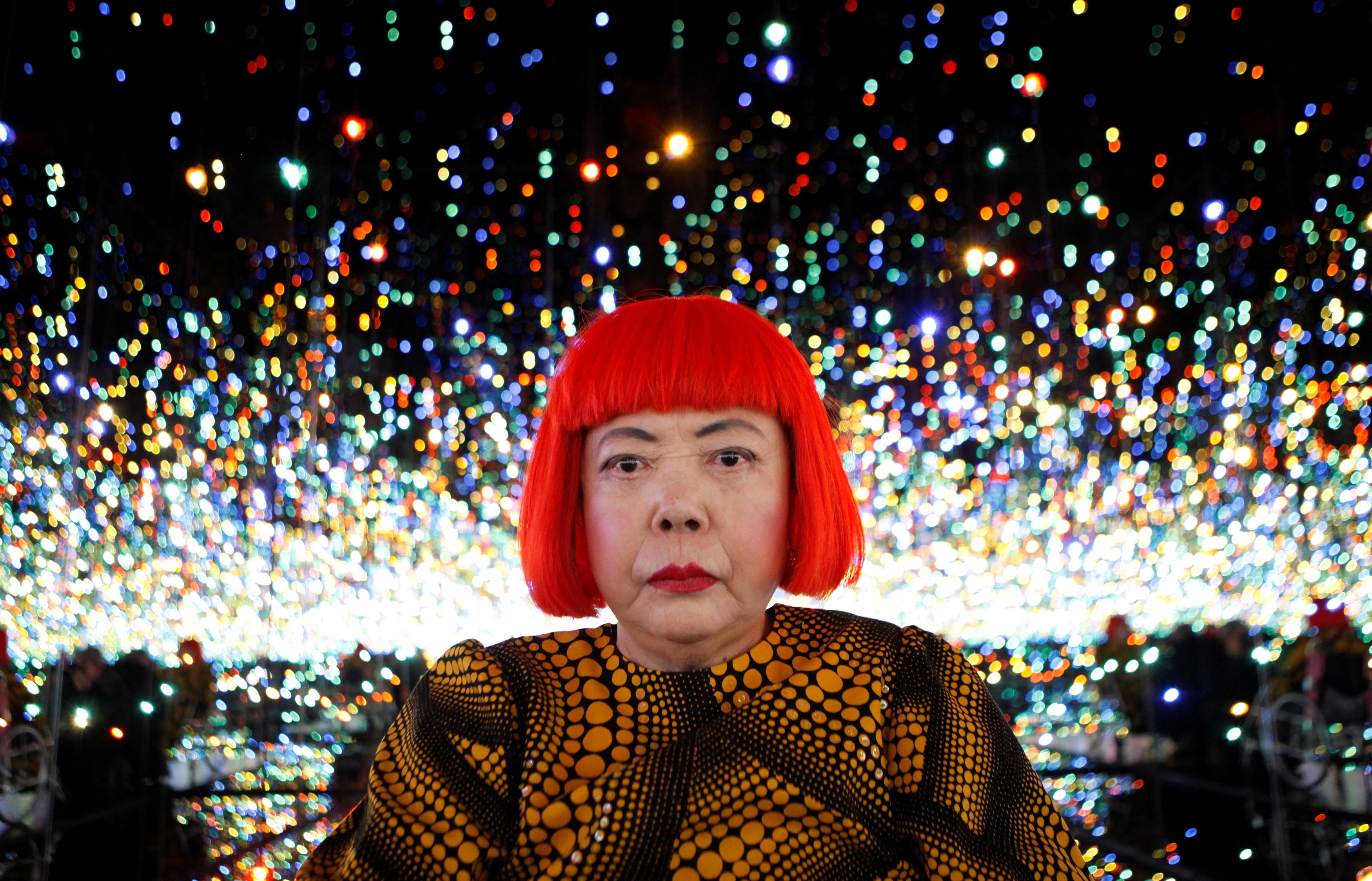 FILE PHOTO: Japanese artist Yayoi Kusama poses for a photograph inside her Infinity Mirrored Room installation titled "The Souls of Millions of Light Years Away" during a media preview of her new exhibition at the David Zwirner gallery in New York, U.S., November 7, 2013. REUTERS/Mike Segar/File Photo TPX IMAGES OF THE DAY