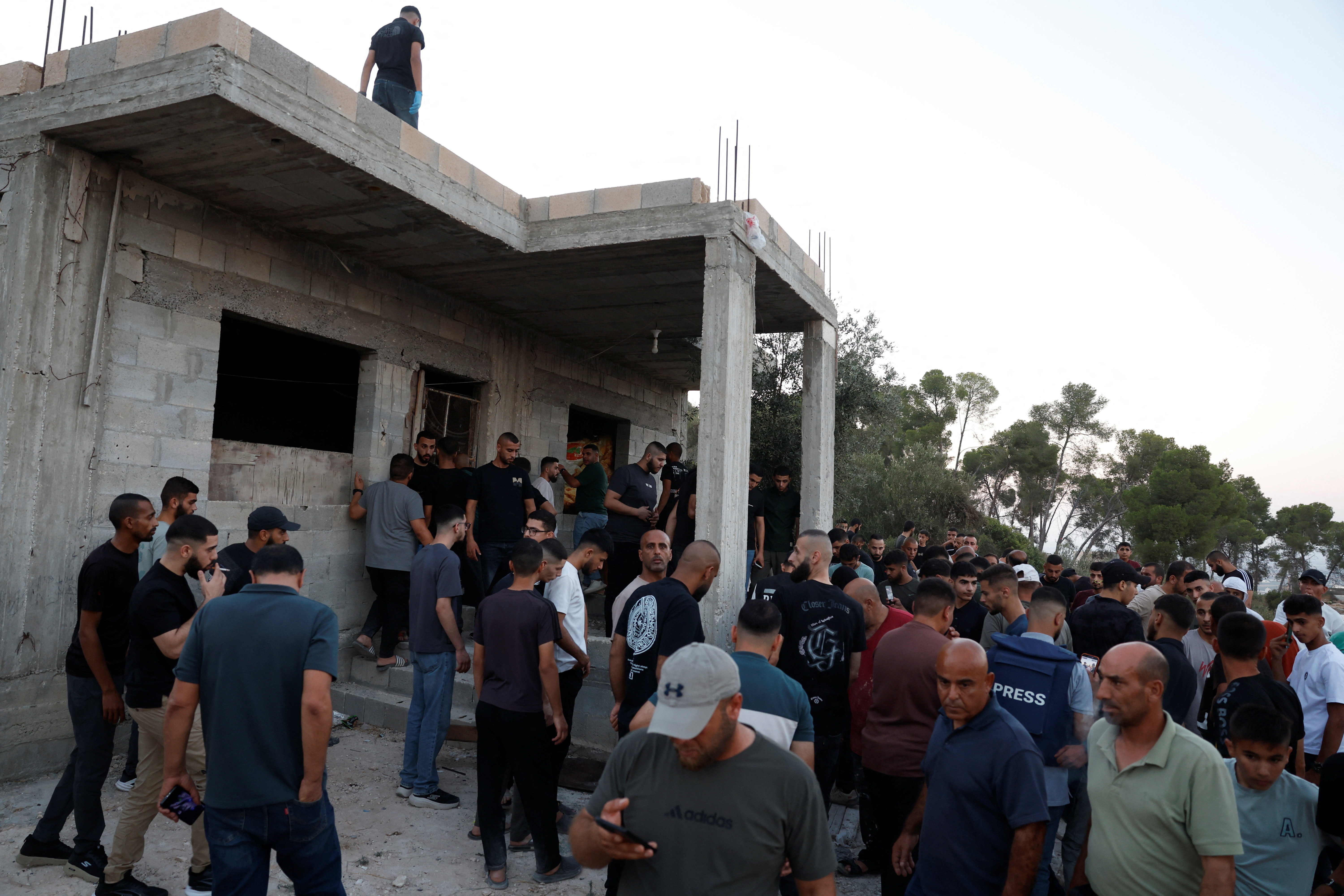 People gather in a building, following an Israeli military airstrike, in Jenin, in the Israeli-occupied West Bank, August 28, 2026. REUTERS/Mohammed Torokman