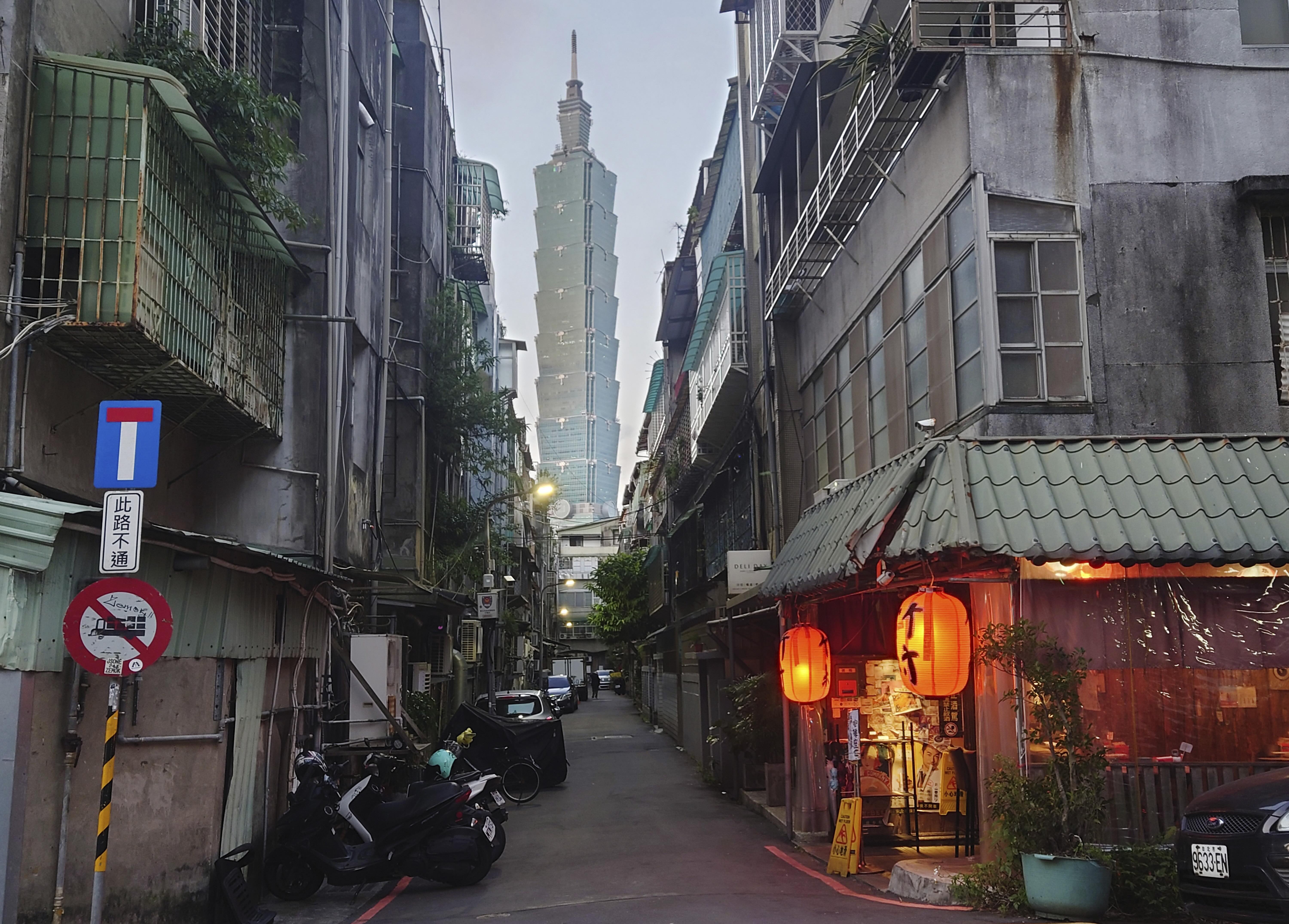 The iconic Taipei 101 skyscraper, the tallest building in Taiwan, can be seen between an alleyway in Taipei on December 26, 2022