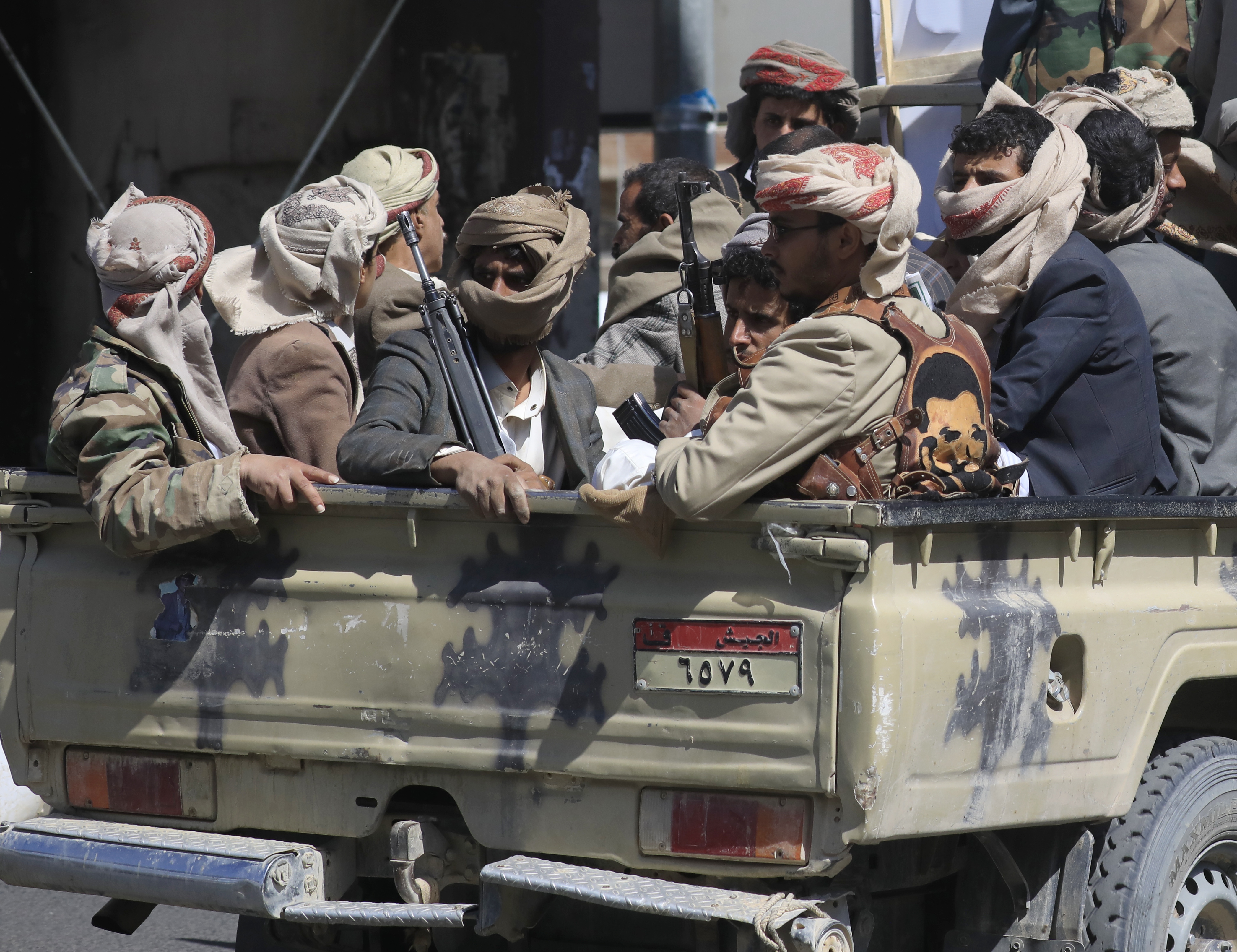 Houthi fighters ride in a pickup truck during a funeral procession for fellow fighters killed in recent fighting in Sanaa, Yemen, September 24, 2026.