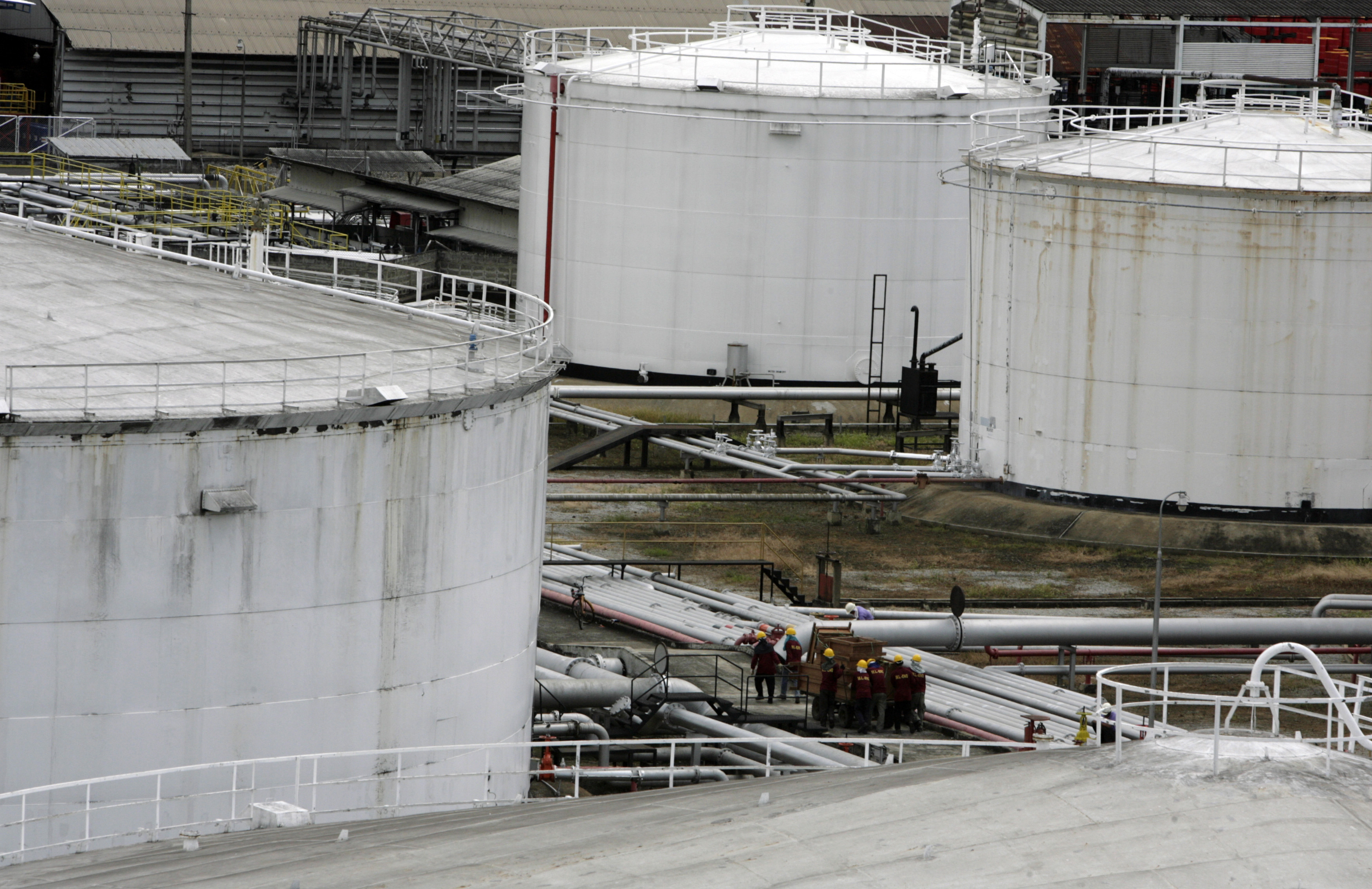 People work at an oil storage facility in Bangkok, Thailand, on September 13, 2007