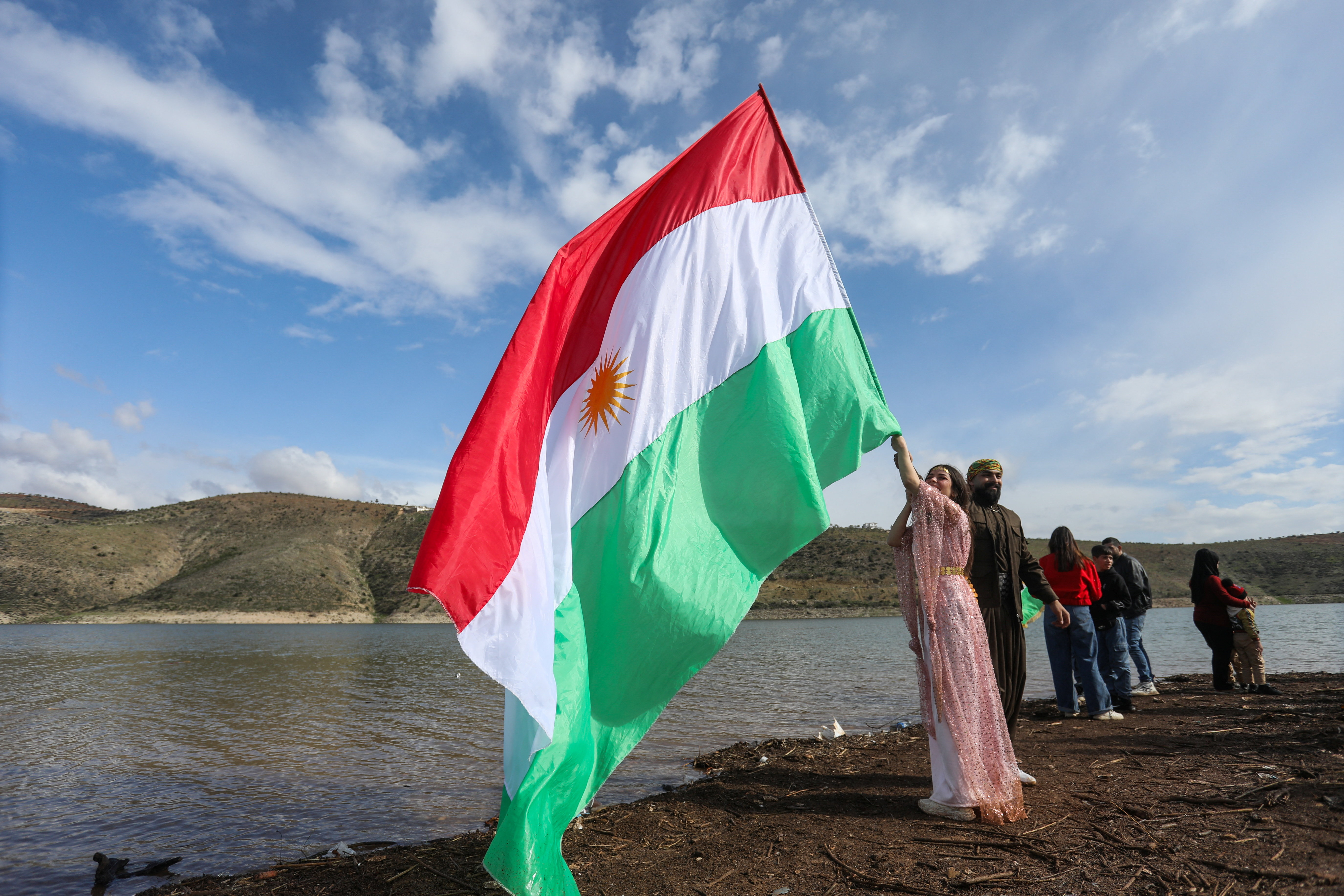 A Syrian Kurdish woman holds a Kurdistan flag during celebrations for the spring festival of Nowruz, in Afrin, Syria