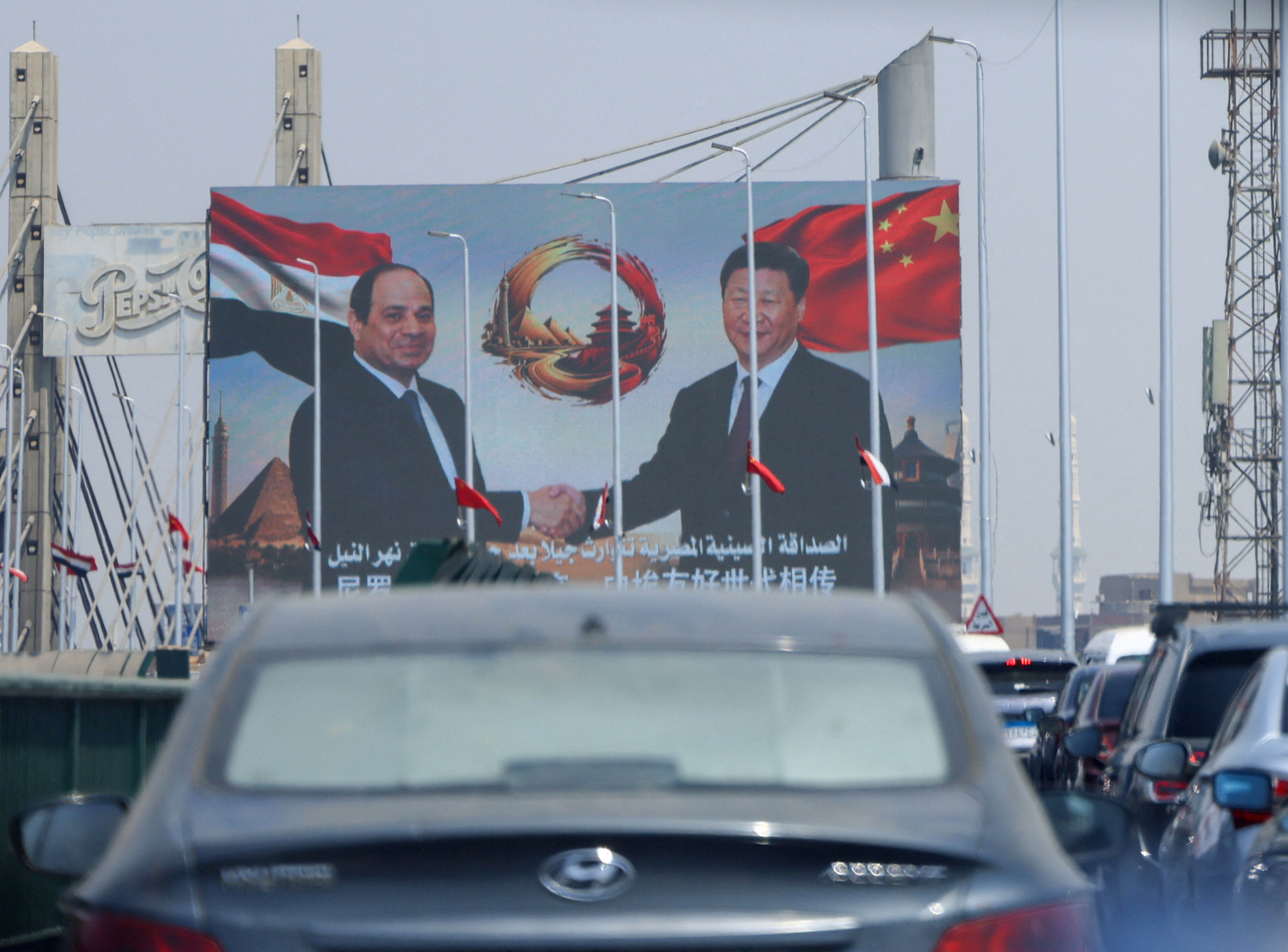 Cars drive in traffic beneath a large screen displaying portraits of Egypt's President Abdel Fattah al-Sisi and China's President Xi Jinping, along with a message reading in Arabic,"The Egyptian-Chinese friendship welcomes Egypt's guest, His Excellency President Xi Jinping, President of the People's Republic of China," ahead of Xi's trip on his first state visit to the North African country in 10 years, during which he is expected to meet President Abdel Fattah al-Sisi and exchange views on bilateral ties, as well as international and regional issues of common concern, in Cairo, Egypt, September 1, 2026. REUTERS/Amr Abdallah Dalsh