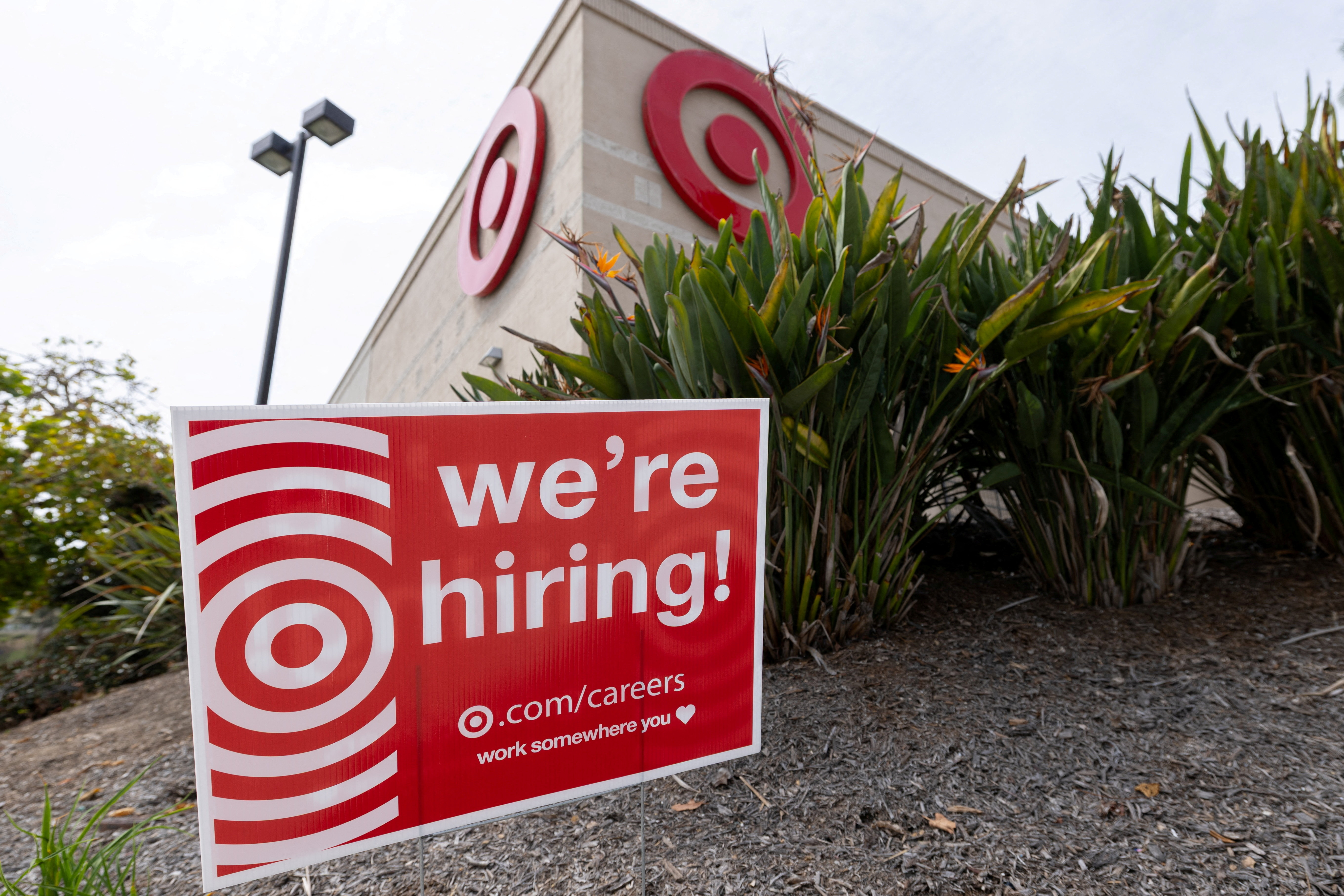 FILE PHOTO: A sign posted outside a Target store states the company is hiring in Encinitas, California, U.S., March 30, 2026. REUTERS/Mike Blake/File Photo