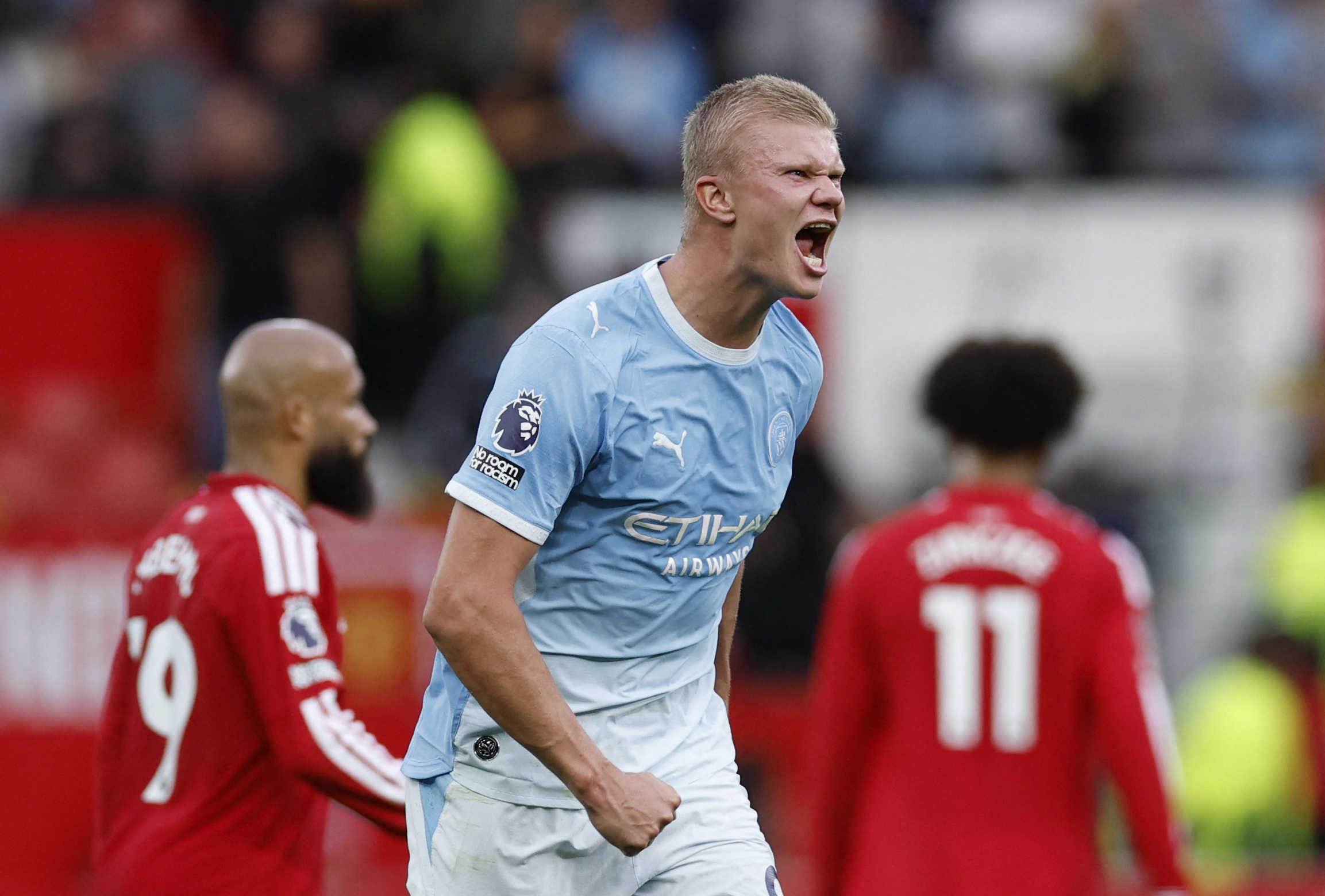 Erling Haaland celebrates on the pitch after the Manchester derby at Old Trafford