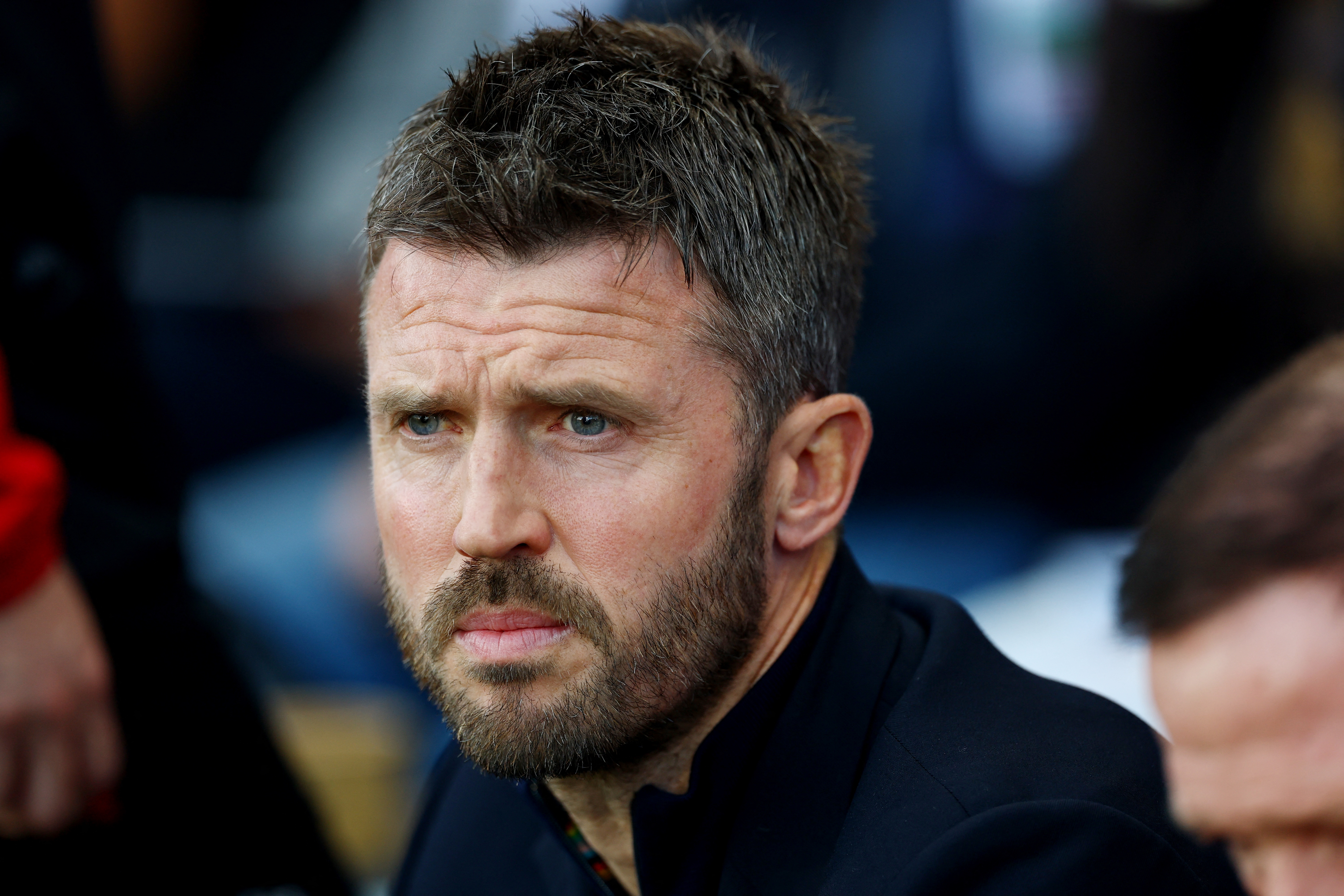 Manchester United manager Michael Carrick looks on.