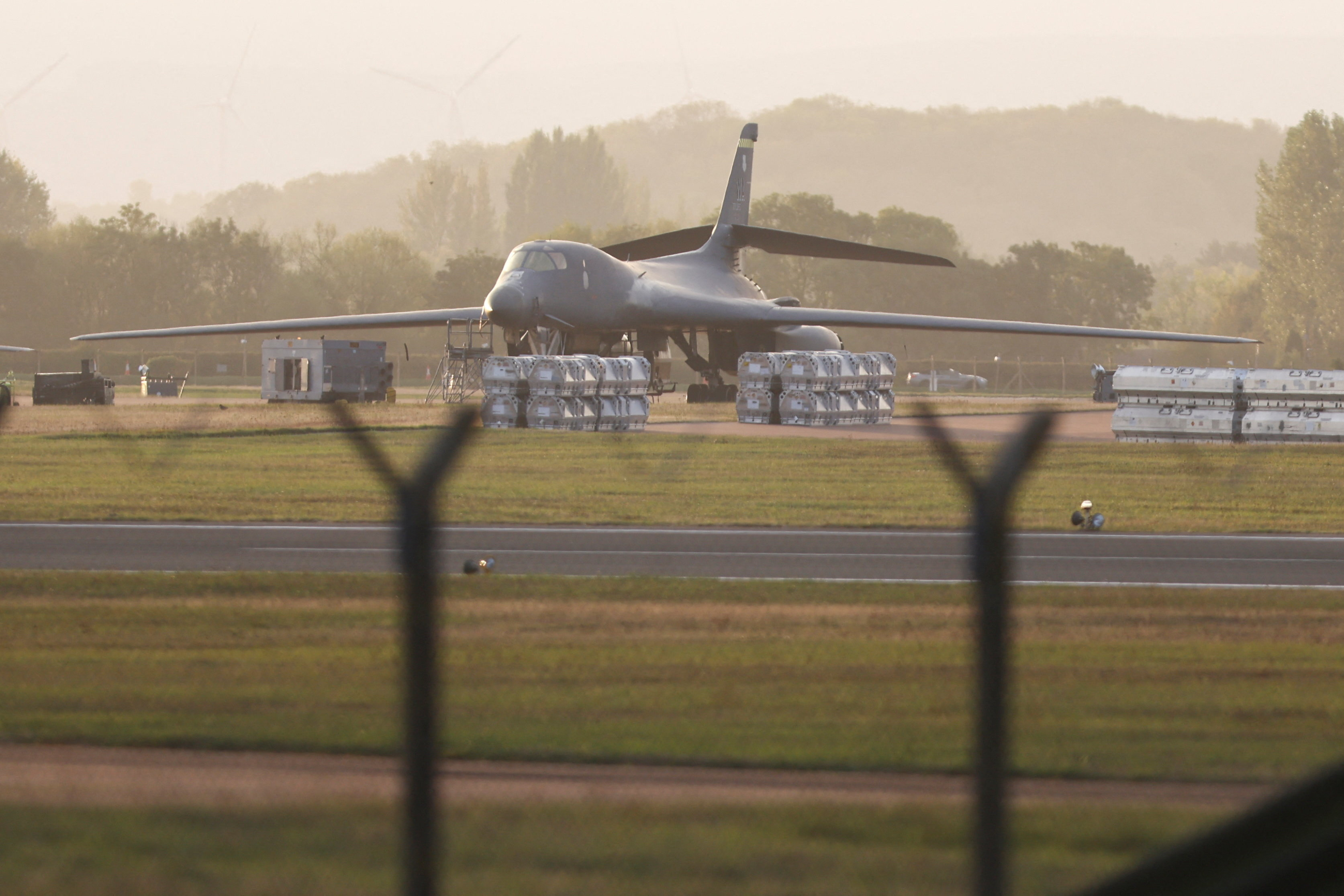 An aircraft is seen in a large field.