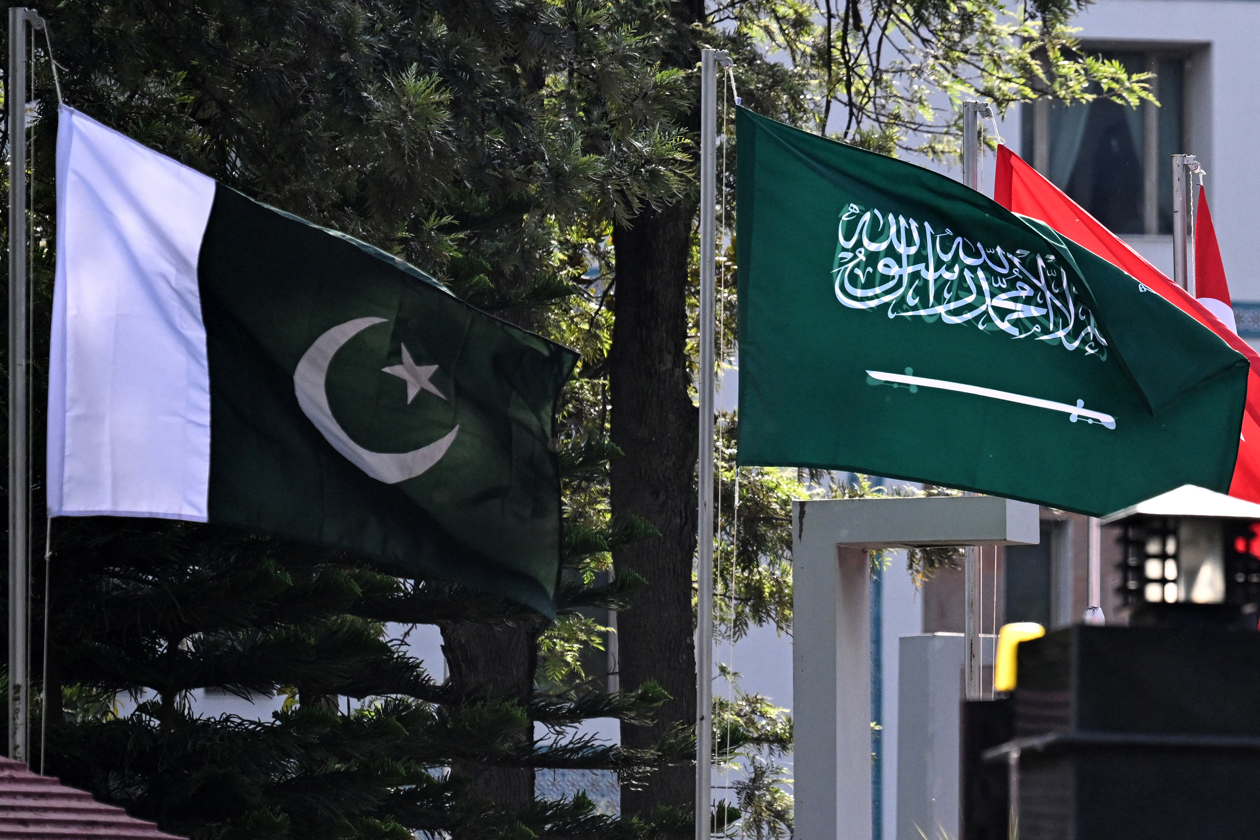 National flags of Pakistan (L) and Saudi Arabia flutter at Pakistan's Ministry of Foreign Affairs premises in Islamabad on March 29, 2026. Foreign ministers from Pakistan, Saudi Arabia, Egypt and Turkey met on March 29 for talks on the war in the Middle East, with Islamabad acting as a go-between for the United States and Iran. (Photo by Aamir QURESHI / AFP)