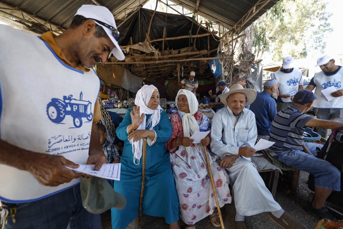 Volunteers from Morocco’s Authenticity and Modernity Party (PAM) distribute campaign leaflets ahead of the September 23 legislative election [Abdel Majid BZIOUAT / AFP]