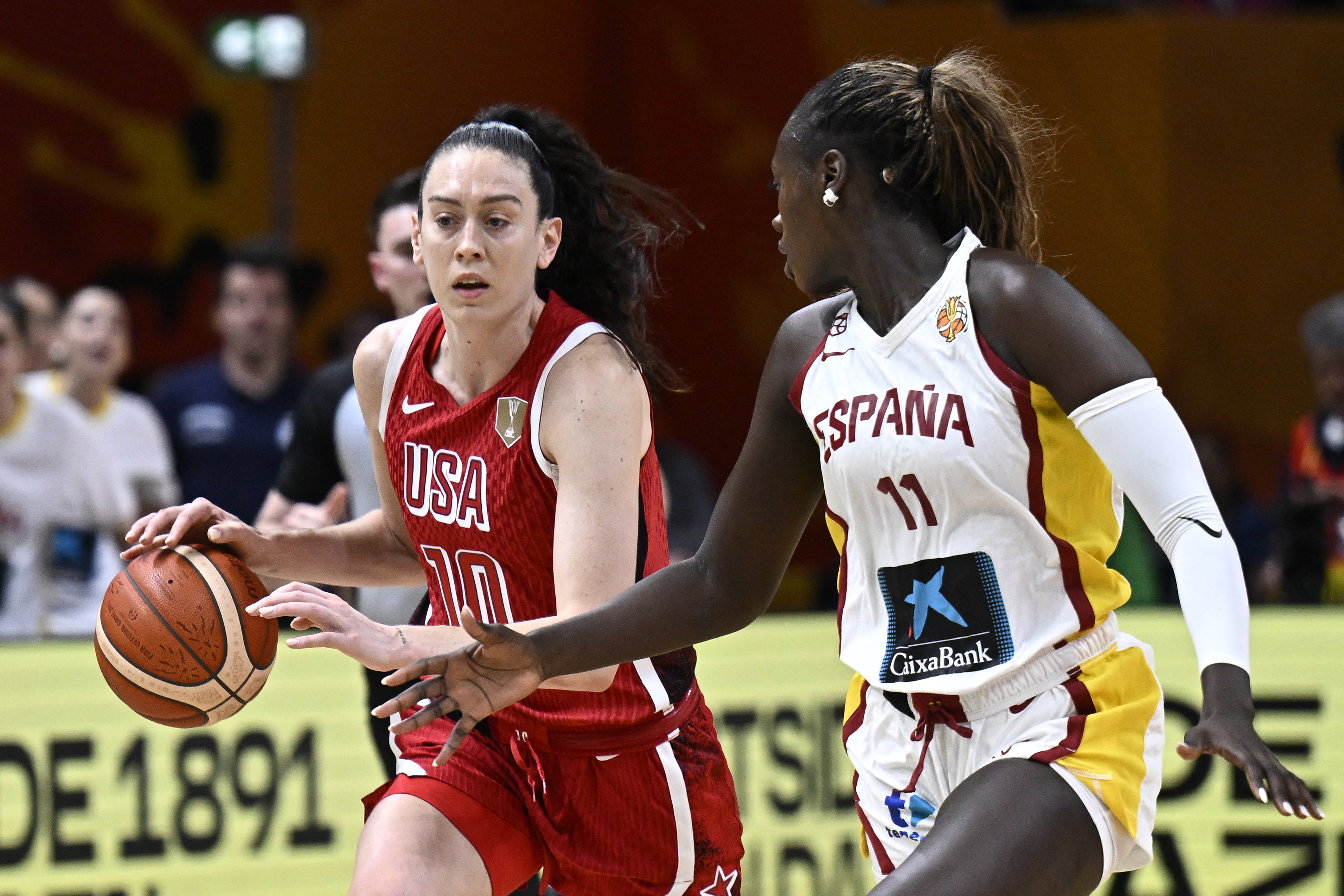 USA's power forward #10 Breanna Stewart and Spain's center #11 Awa Fam vie for the ball during the 2026 FIBA Women's Basketball World Cup semi-final match between Spain and the United States in Berlin on September 12, 2026. (Photo by Tobias SCHWARZ / AFP)