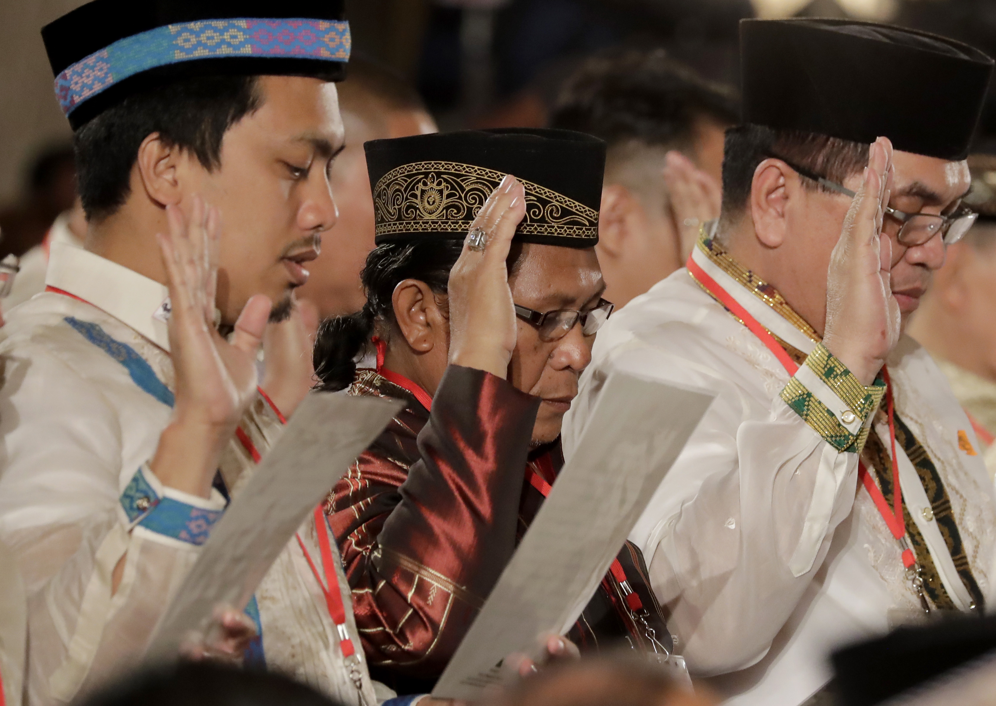 Abdullah Macapaar, centre, along with some of the fiercest Muslim rebel commanders in the southern Philippines, takes his oath during a ceremony for the creation of the Bangsamoro Transition Authority (BTA) at the Presidential Palace in Manila, Philippines, on February 22, 2019