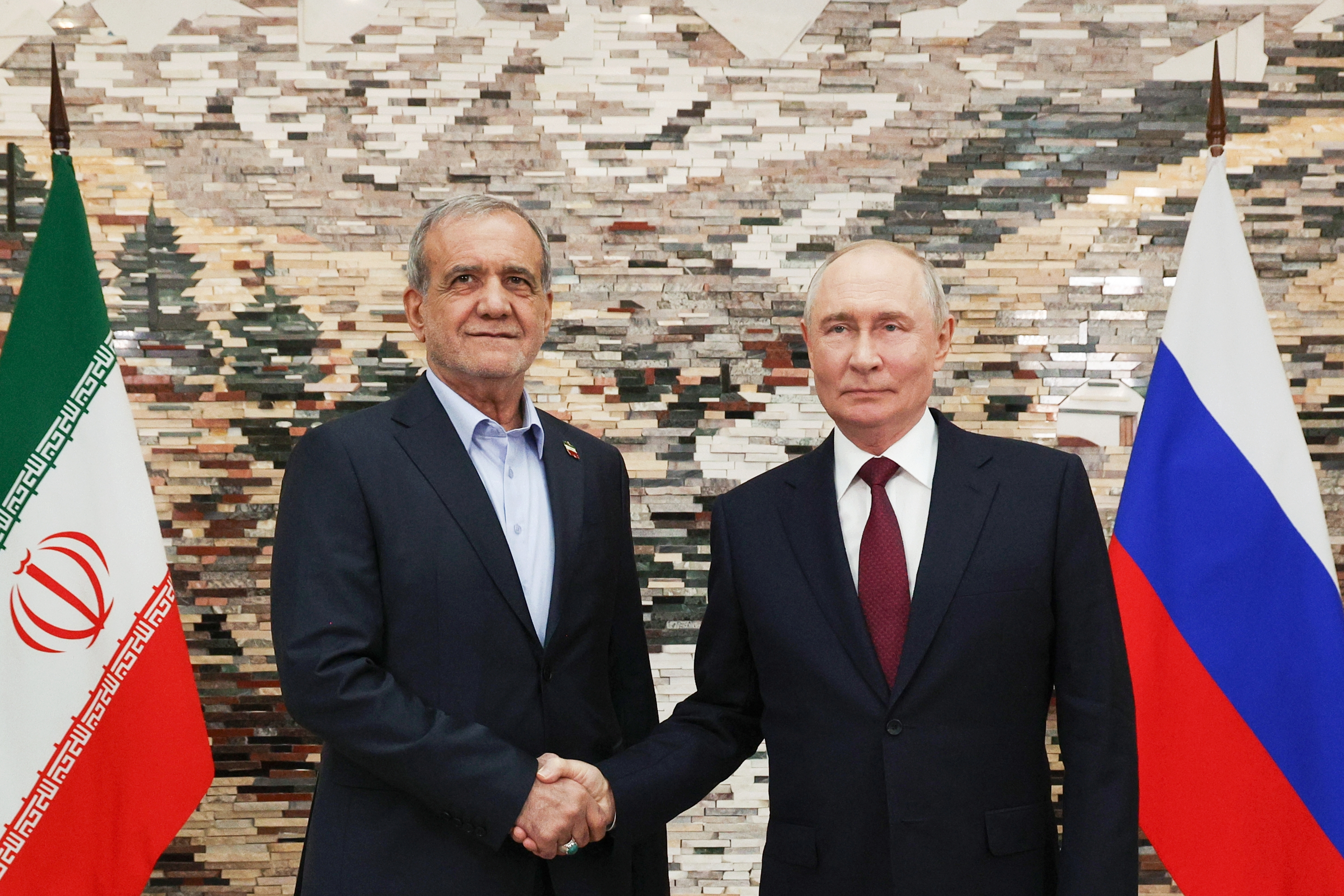 Russian President Vladimir Putin, right, and Iranian President Masoud Pezeshkian pose for a photo during their meeting on the sidelines of the Shanghai Cooperation Organization (SCO), in Bishkek, Kyrgyzstan, on Tuesday, Sept. 1, 2026. (Vyacheslav Prokofyev, Sputnik, Kremlin Pool Photo via AP)