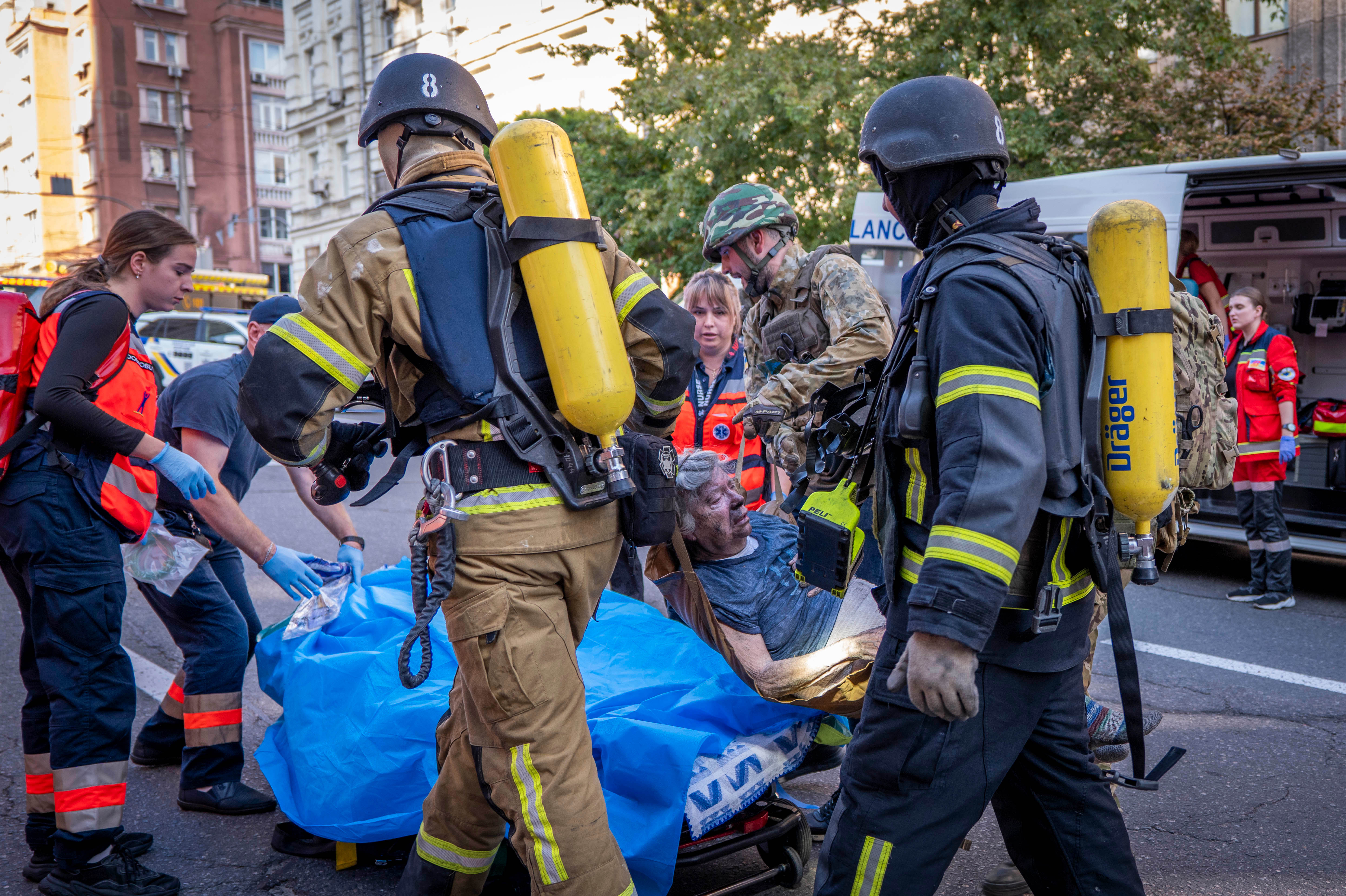 Rescue workers evacuate an injured woman from a hospital damaged after a Russian drone attack in central Kyiv, Ukraine, in September