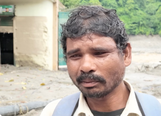 Talka Sada, backpack on his shoulders, is trekking across Nepal's flood-hit areas, searching for his missing son. [Smita Sharma/ Al Jazeera]