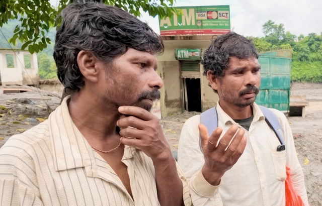 Talka Sada, right, and his brother, are searching for Sada's son, who has been missing since the August 25 floods that devastated large parts of northern Nepal [Smita Sharma/ Al Jazeera]