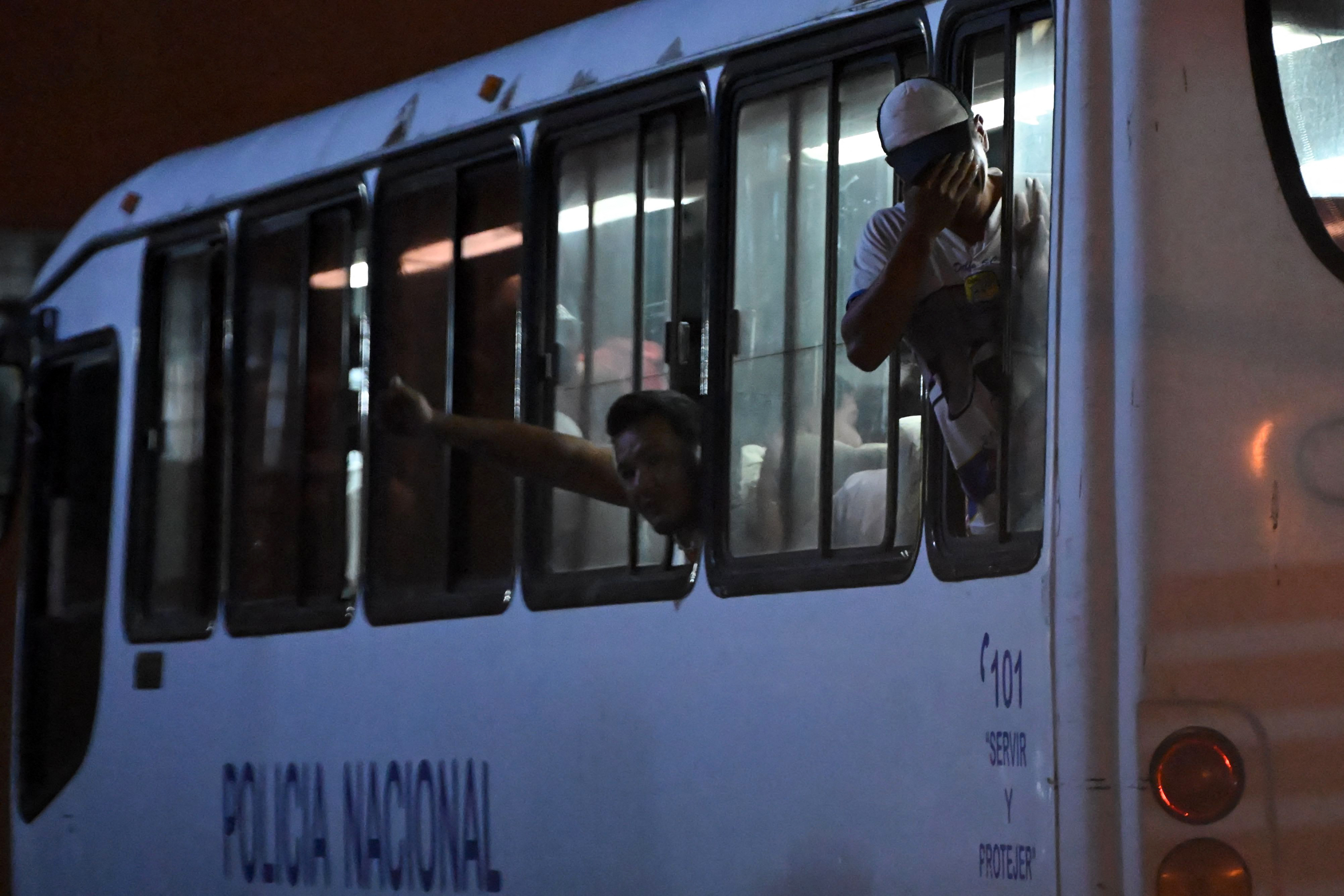 A group of detained fishermen are transported on a National Police bus to the Community Surveillance Unit (UVC) from the port of Manta. [AFP]