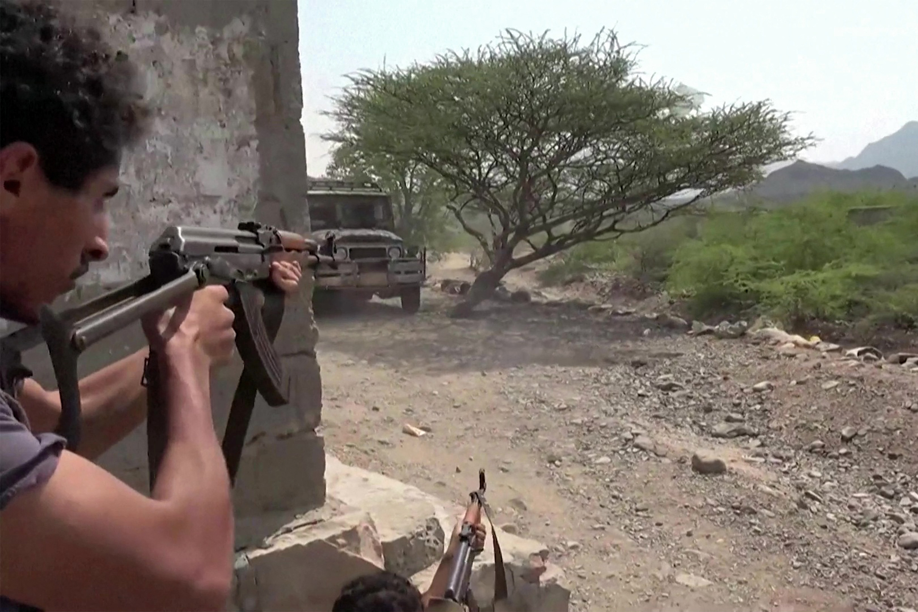 TOPSHOT - This screen grab taken from video footage released on September 8, 2026 by the Saudi-backed National Resistance Forces in Yemen shows fighters firing assault rifles from a position next to cover, as Yemeni government forces and National Resistance Forces fire at Houthi fighters on the Kadha front, west of the city of Taiz in Yemen's western Taiz province.