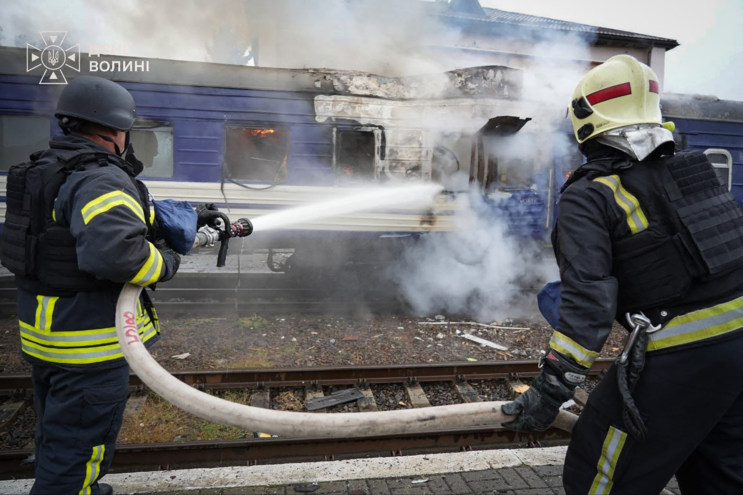 This handout picture taken and released by the Ukrainian State Emergency Service on September 13, 2026 shows firefighters spraying water at a train carriage damaged by a drone strike near the border with Poland.