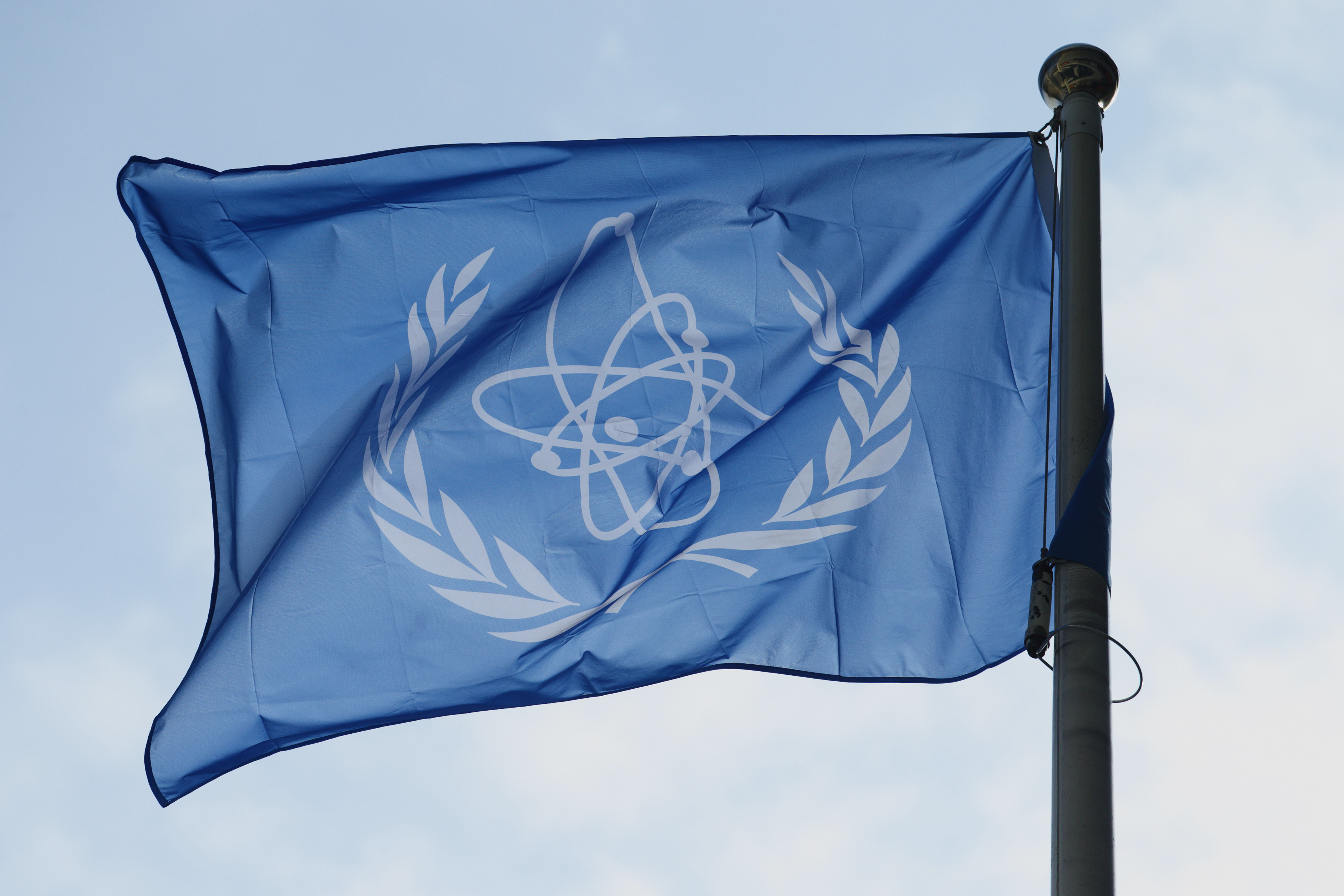 FILE - The flag of the International Atomic Energy Agency (IAEA) flies during a special session of an IAEA Board of Governors meeting in Vienna, Austria, March 2, 2026. (AP Photo/Heinz-Peter Bader, File)