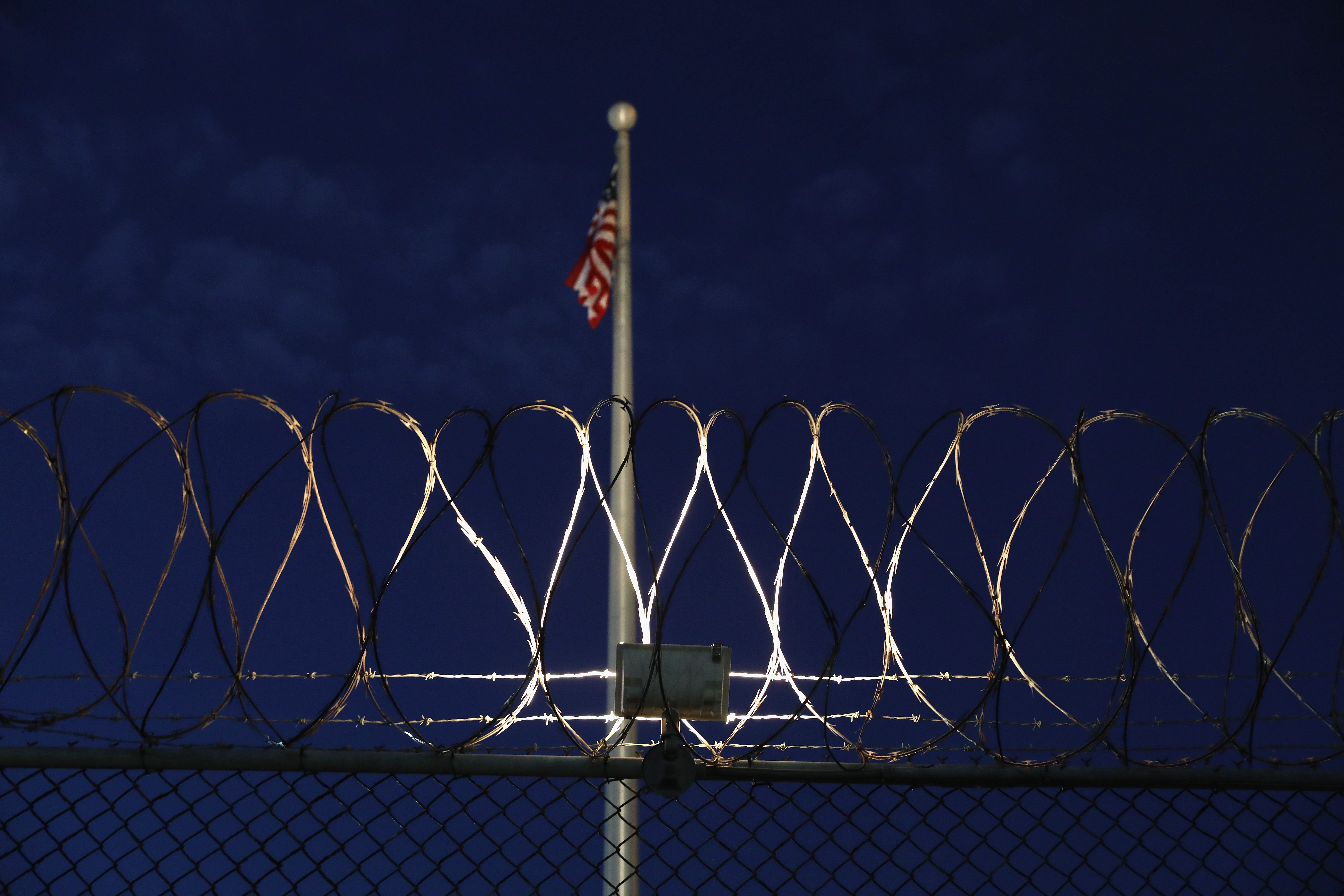 GUANTANAMO BAY, CUBA - OCTOBER 22: (EDITORS NOTE: Image has been reviewed by the U.S. Military prior to transmission.) Razor wire lines the fence of the "Gitmo" detention center on October 22, 2016 at the U.S. Naval Station at Guantanamo Bay, Cuba. The U.S. military's Joint Task Force Guantanamo is still holding 60 detainees at the prison, down from a previous total of 780. On his second day in office in 2008 President Obama issued an executive order to close the prison, which has failed because of political opposition in the U.S. (Photo by John Moore/Getty Images)