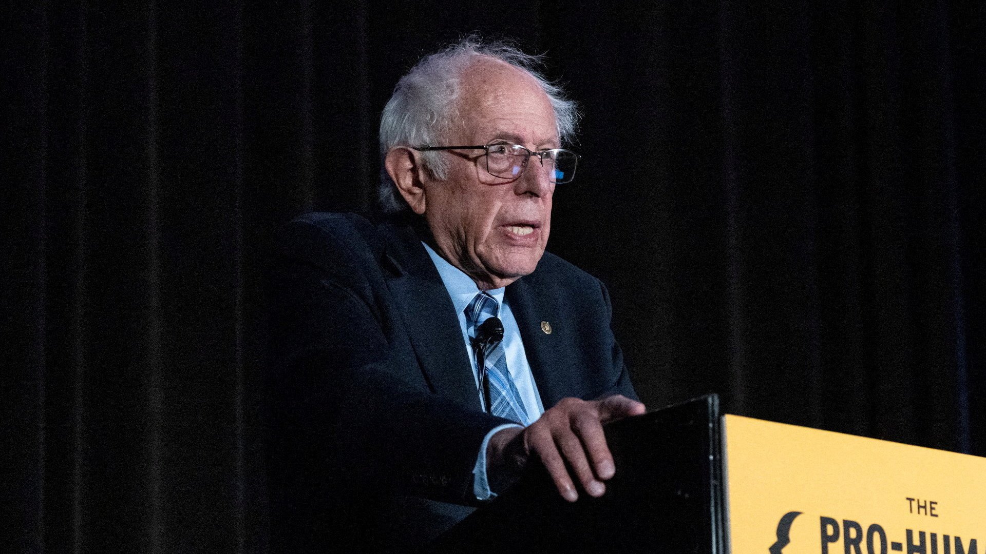 Bernie Sanders standing near a podium