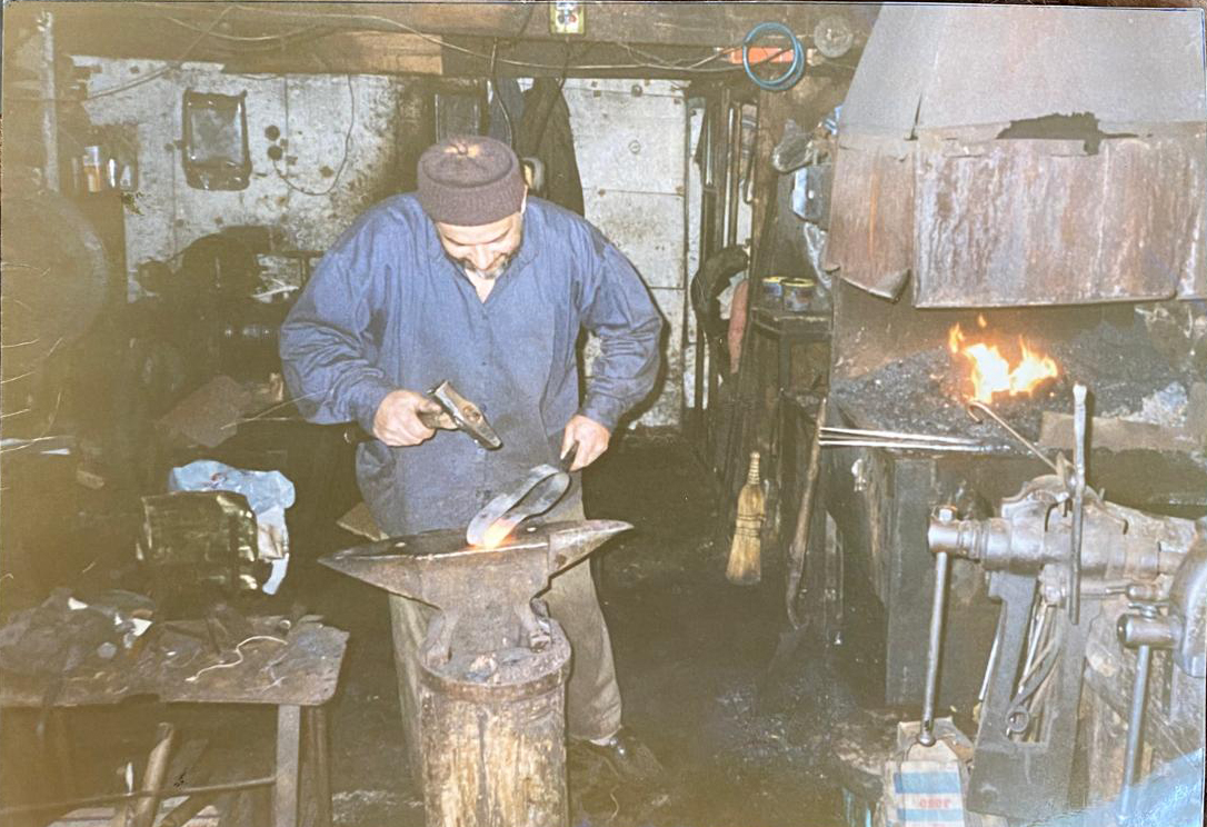Suleyman Akdemir, the family patriarch, at work in the family’s blacksmith workshop in Kemeralti, circa 1990s [Courtesy of Akdemir family]