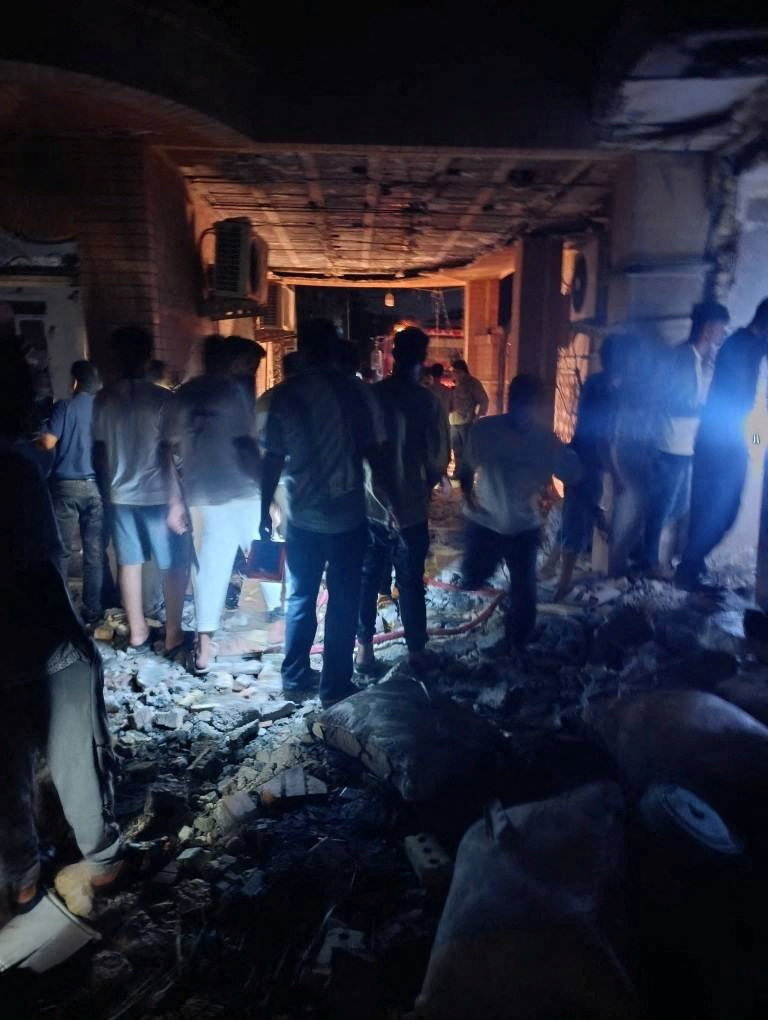 People gather at the site of an attack.