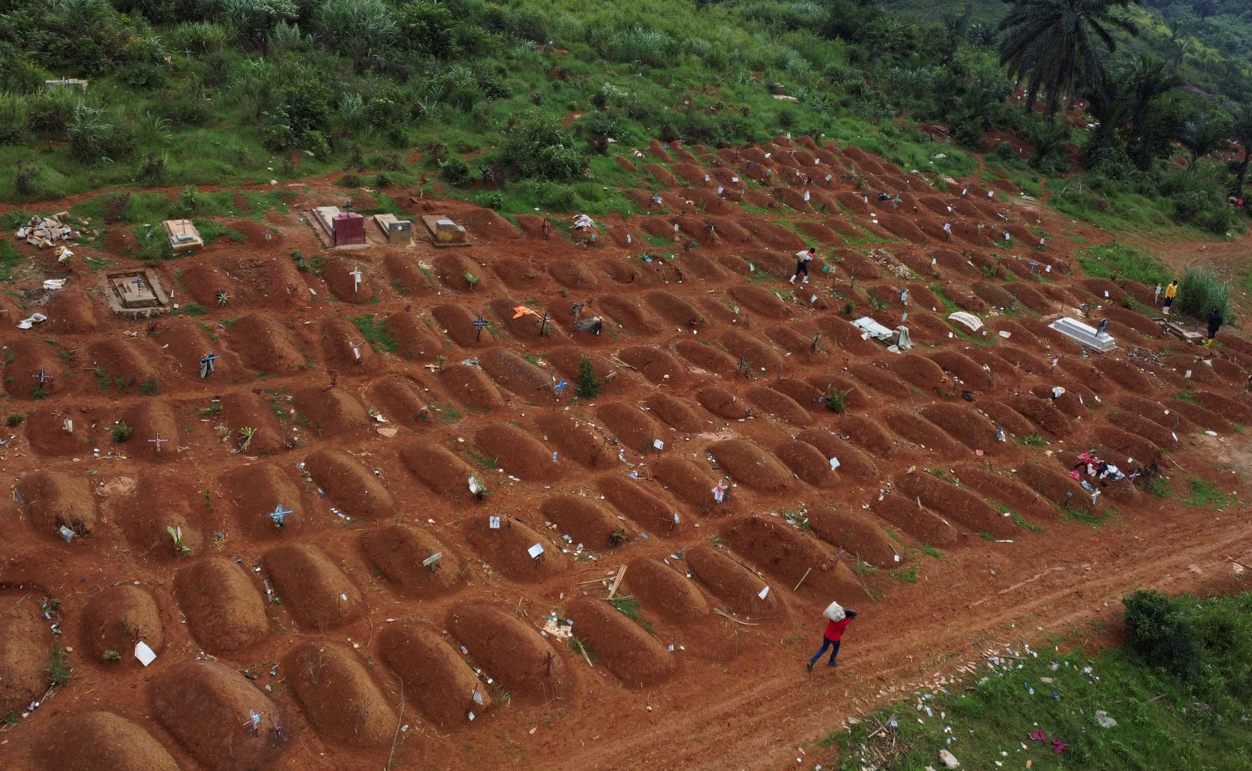Workers at the Ceca-20 cemetery in Mongbwalu, Ituri province, Democratic Republic of the Congo, on July 14, 2026, as aid agencies intensify efforts to contain an Ebola outbreak caused by the Bundibugyo virus
